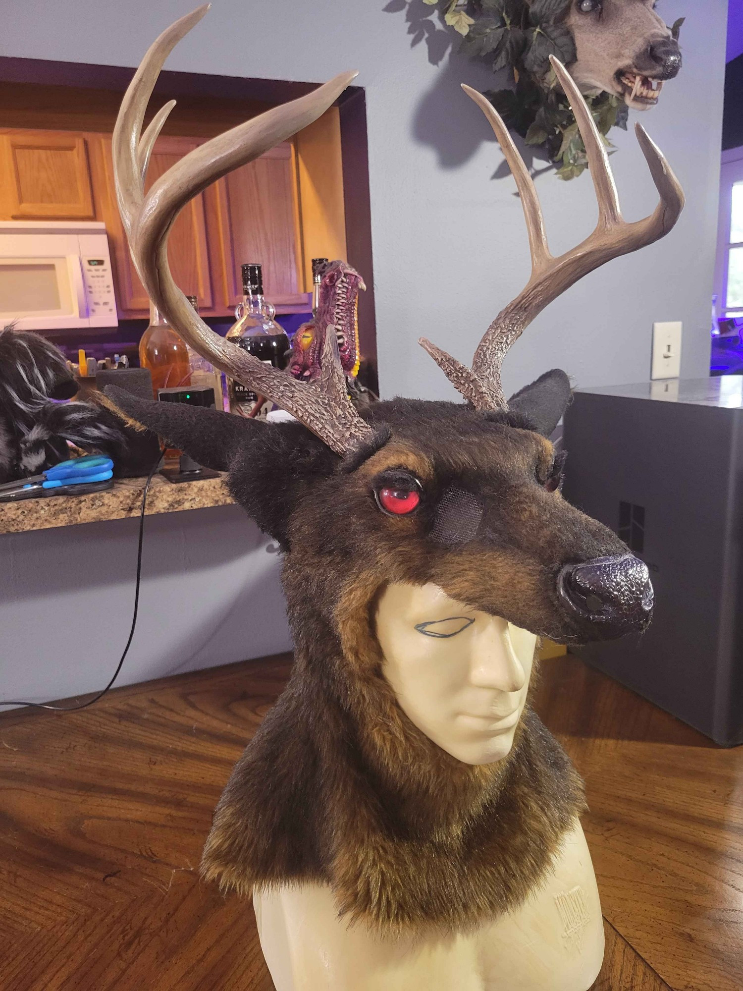 Dark brown stag half mask with red eyes