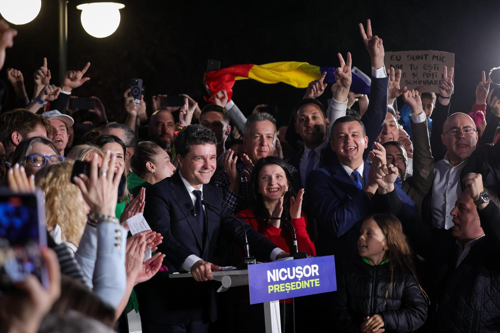 President Nicușor Dan surrounded by supporters, friends, and family 