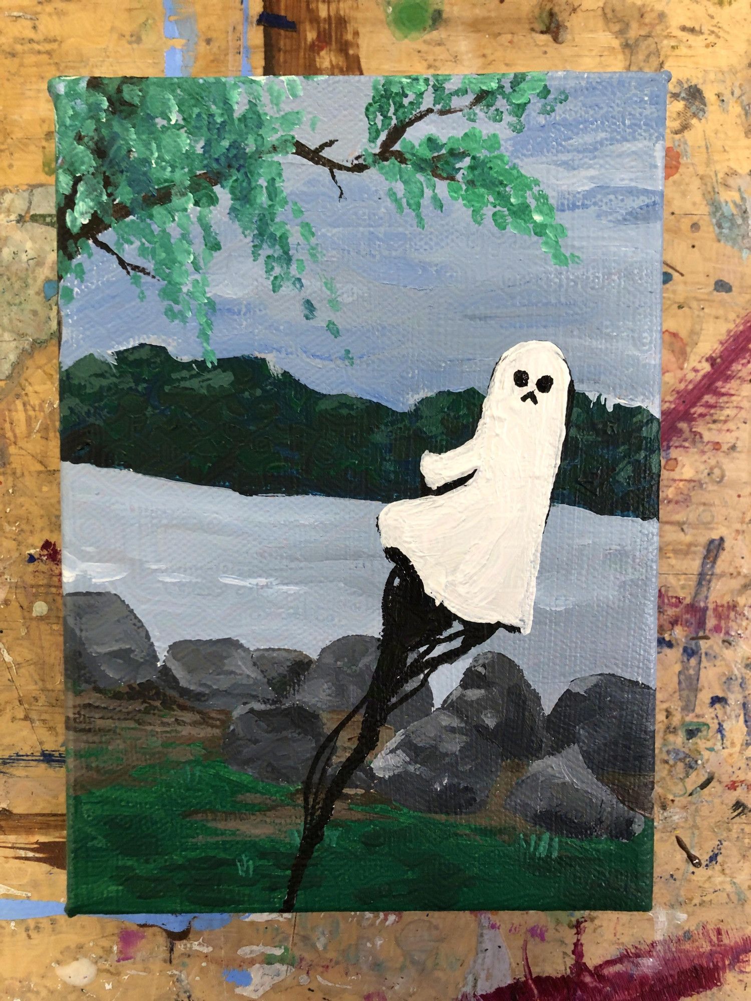 A small painting of a ghost floating beside a stony riverbed. A willow tree leans into the upper left corner. The ghost is trailing an ominous black stream behind it.