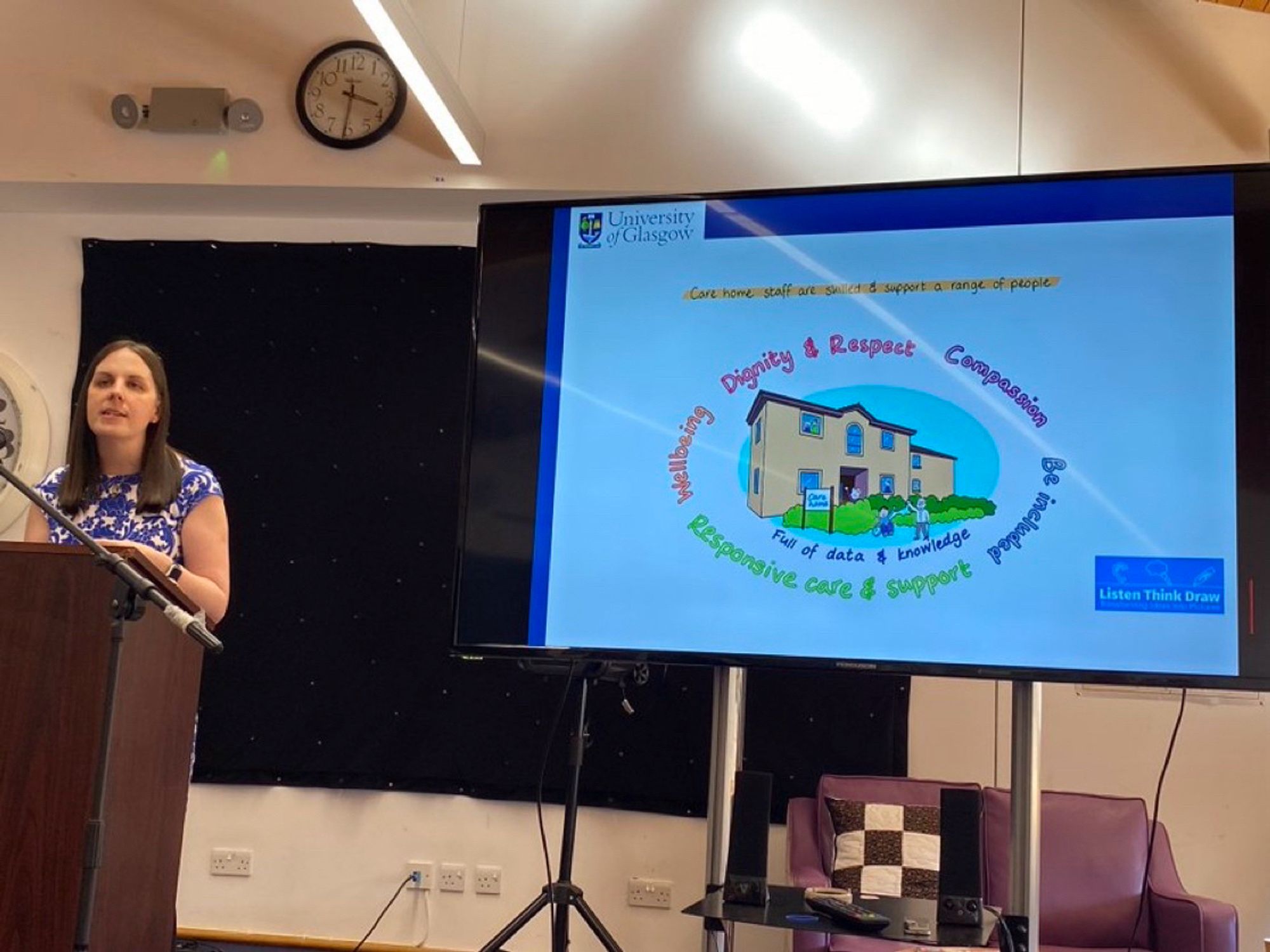 Presenting a slide with the Health and social care standards around a care home image