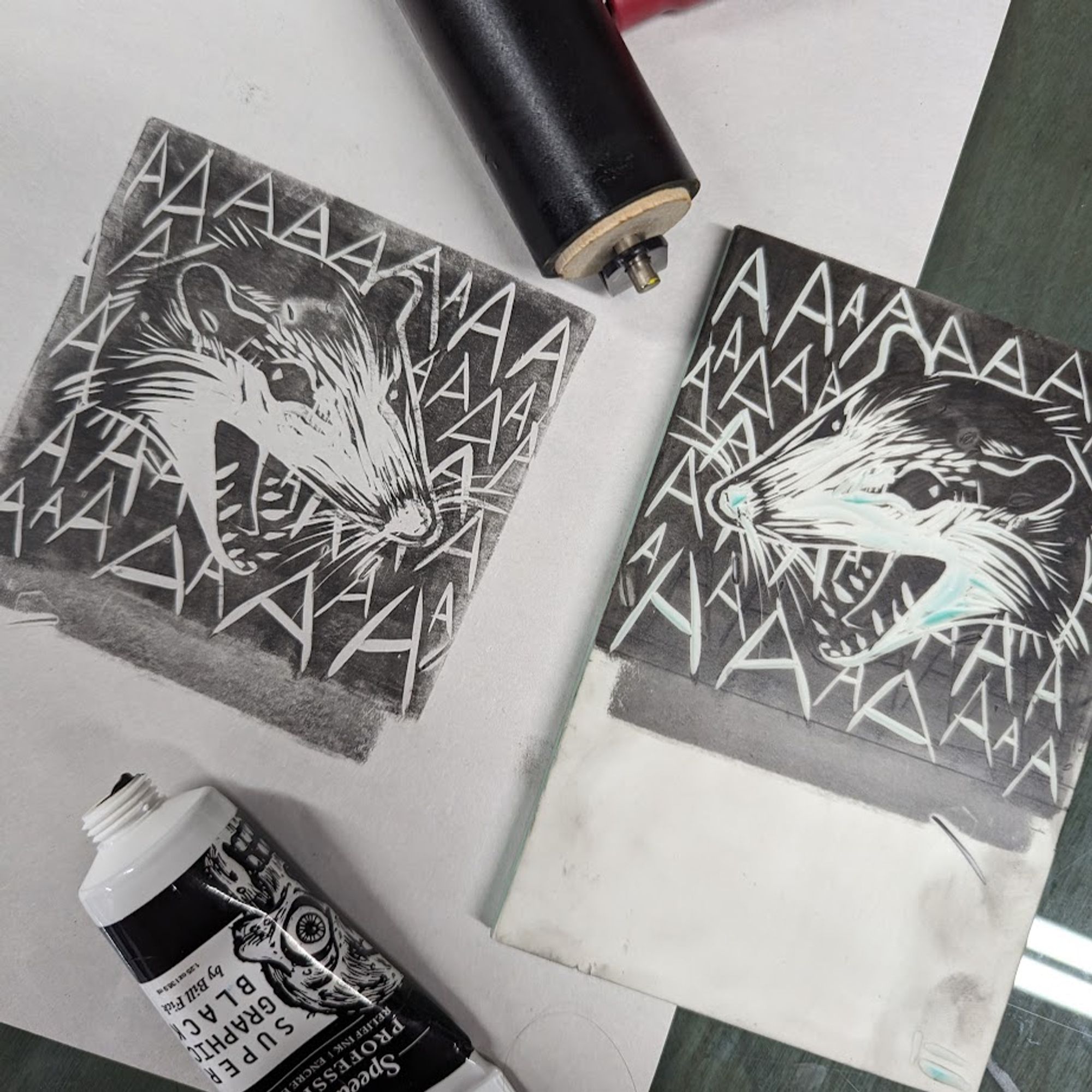 photo of a carved block and print of an opossum head screaming AAAAAA