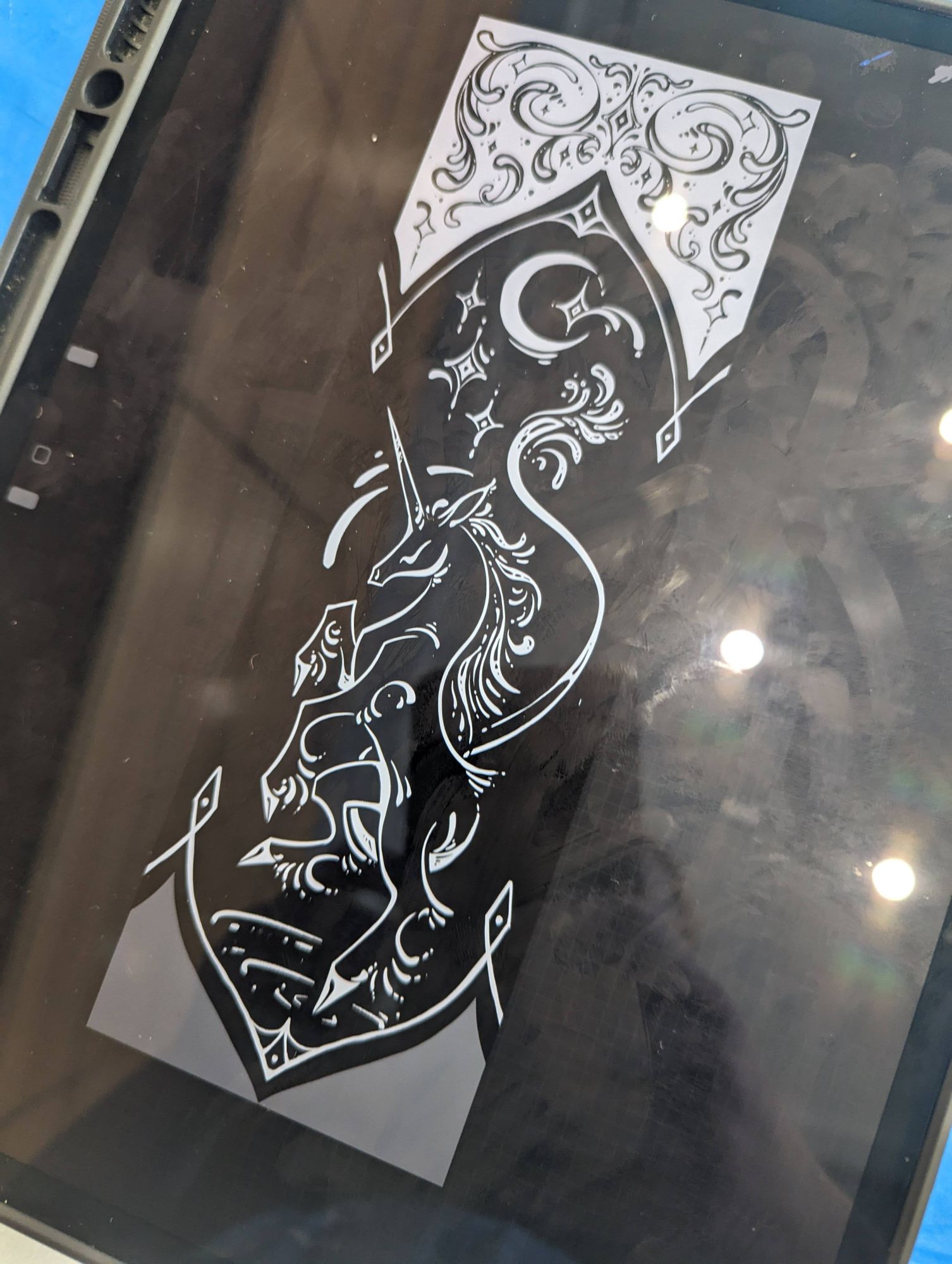 Photo of iPad screen with ornamental unicorn design on ribbon tail