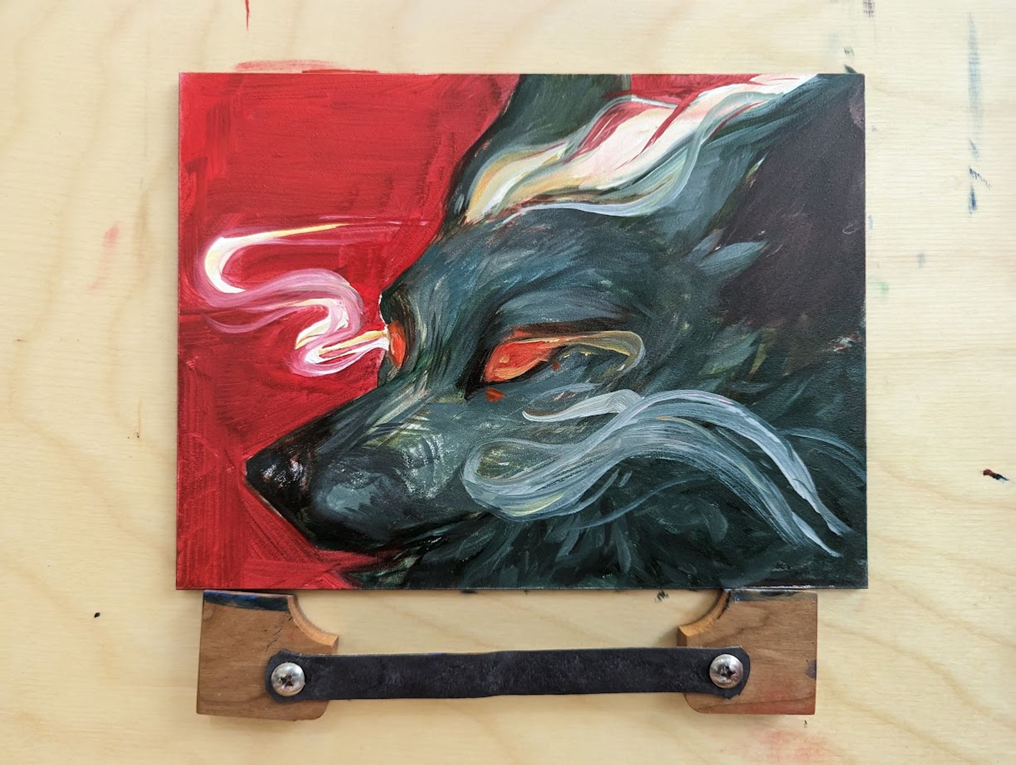 a small oil painting of a dark forest-green canine with abstracted smoke trails against a red background