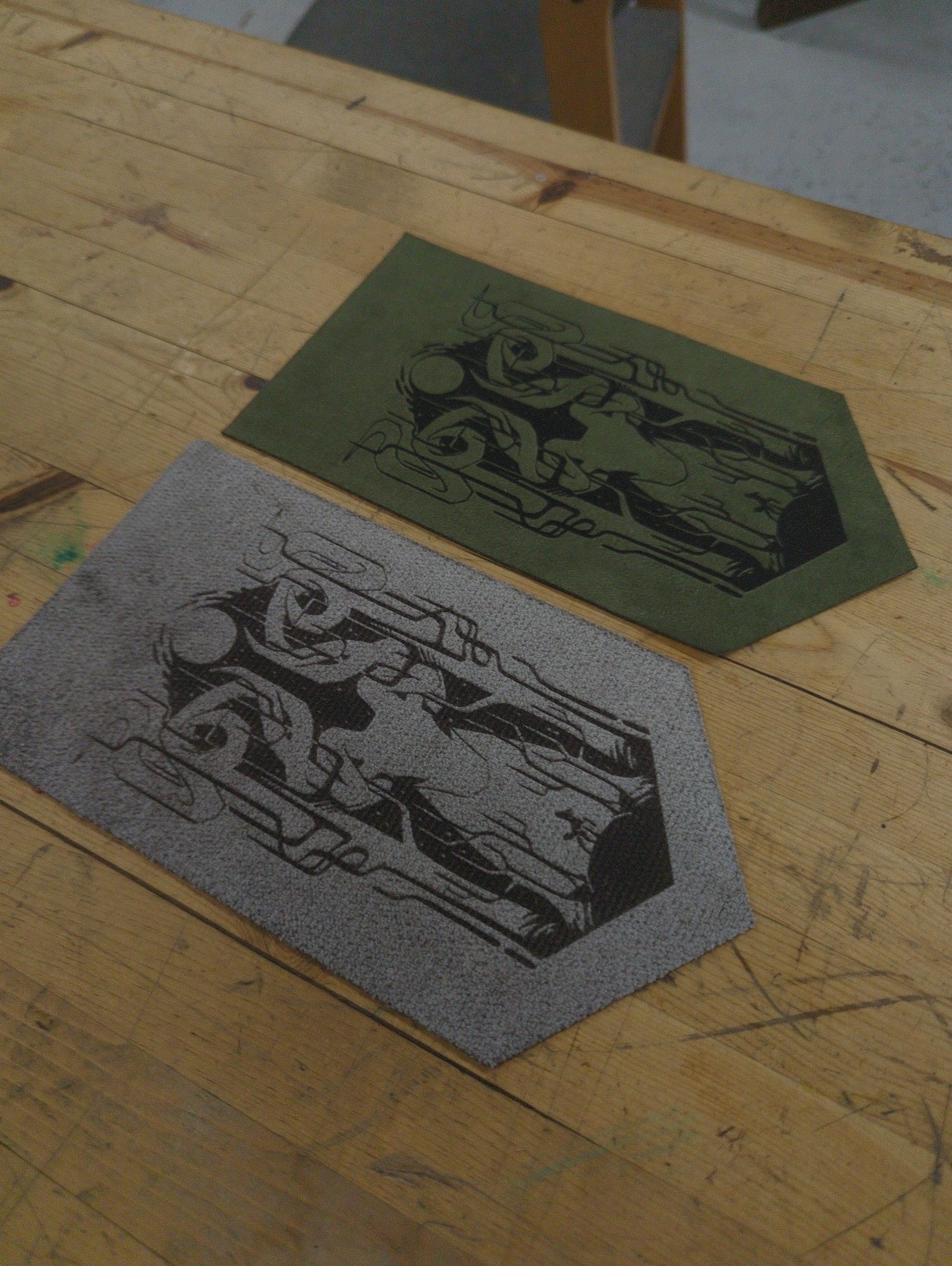 Metallic silver and army green suede banners with a graphic deer design engraved into them