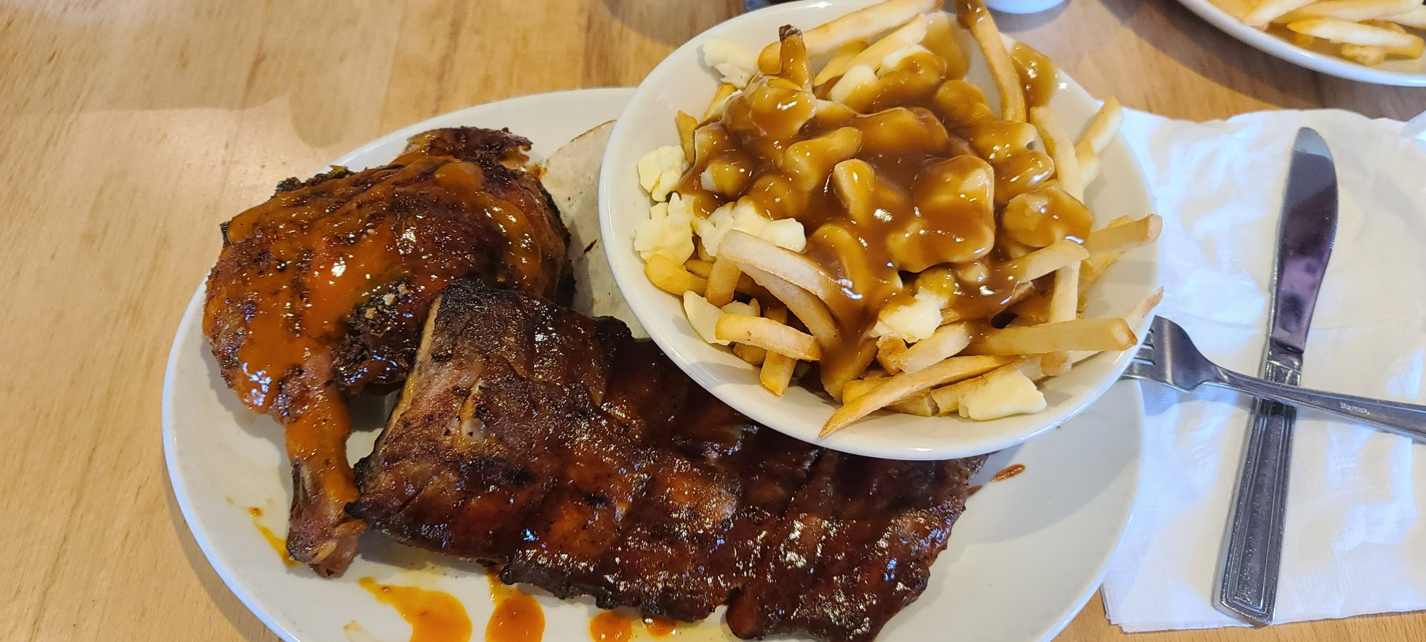 extra spicy jerk chicken with bourbon sauce ribs with a poutine 