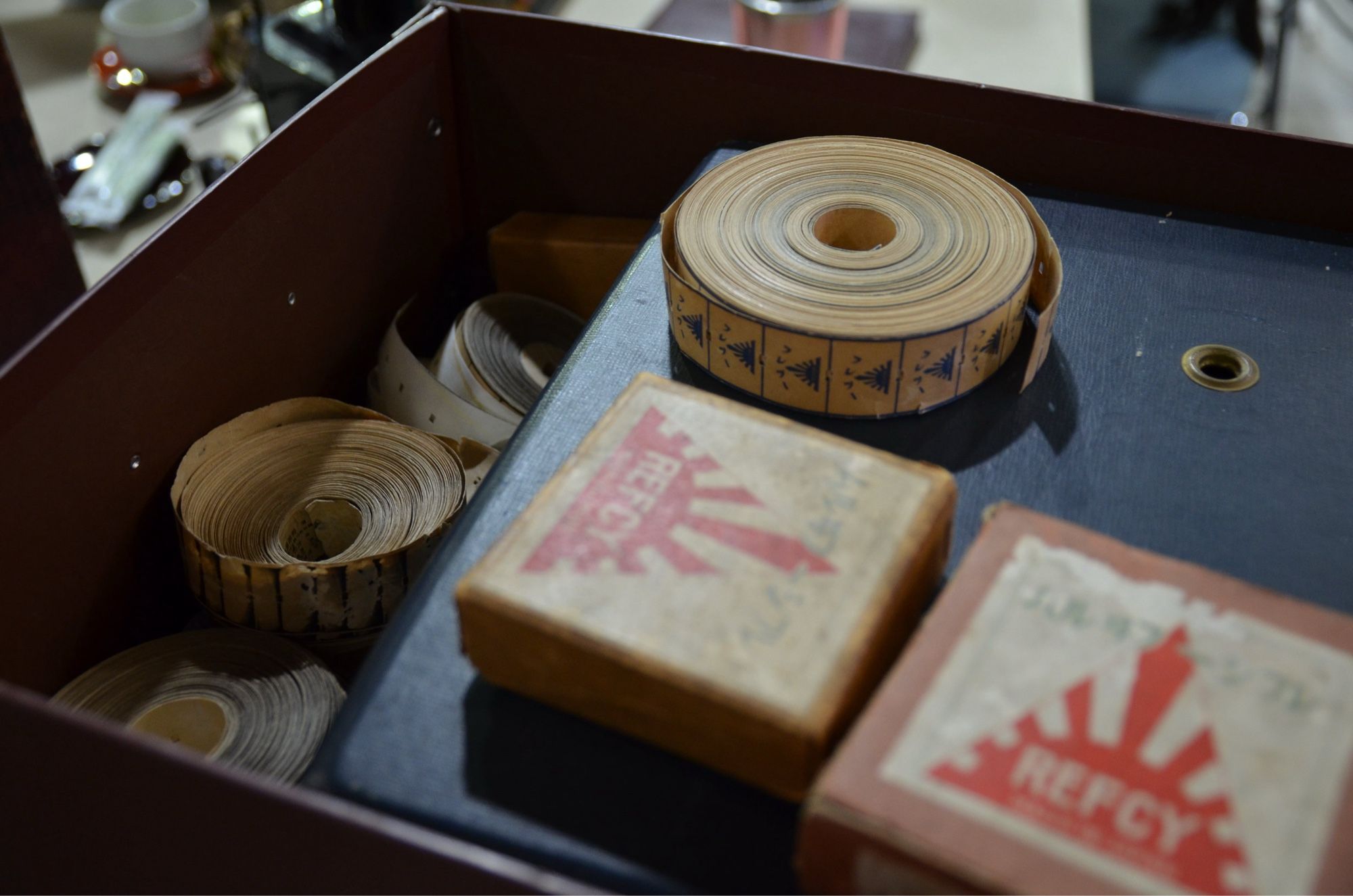 A close-up photo of some rolls of Japanese paper films in a box.