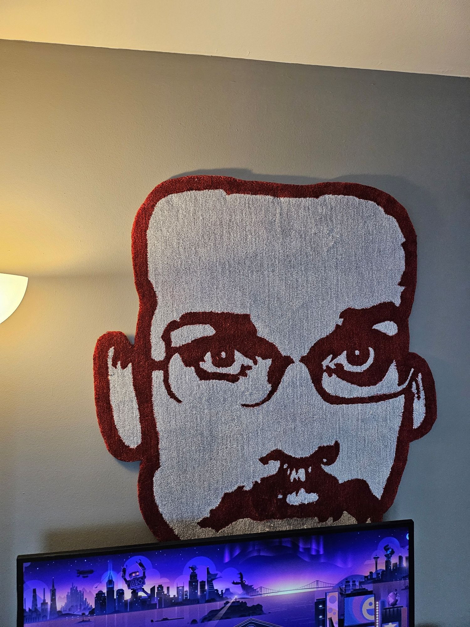 A Pizza John rug, nailed to a wall behind my television.