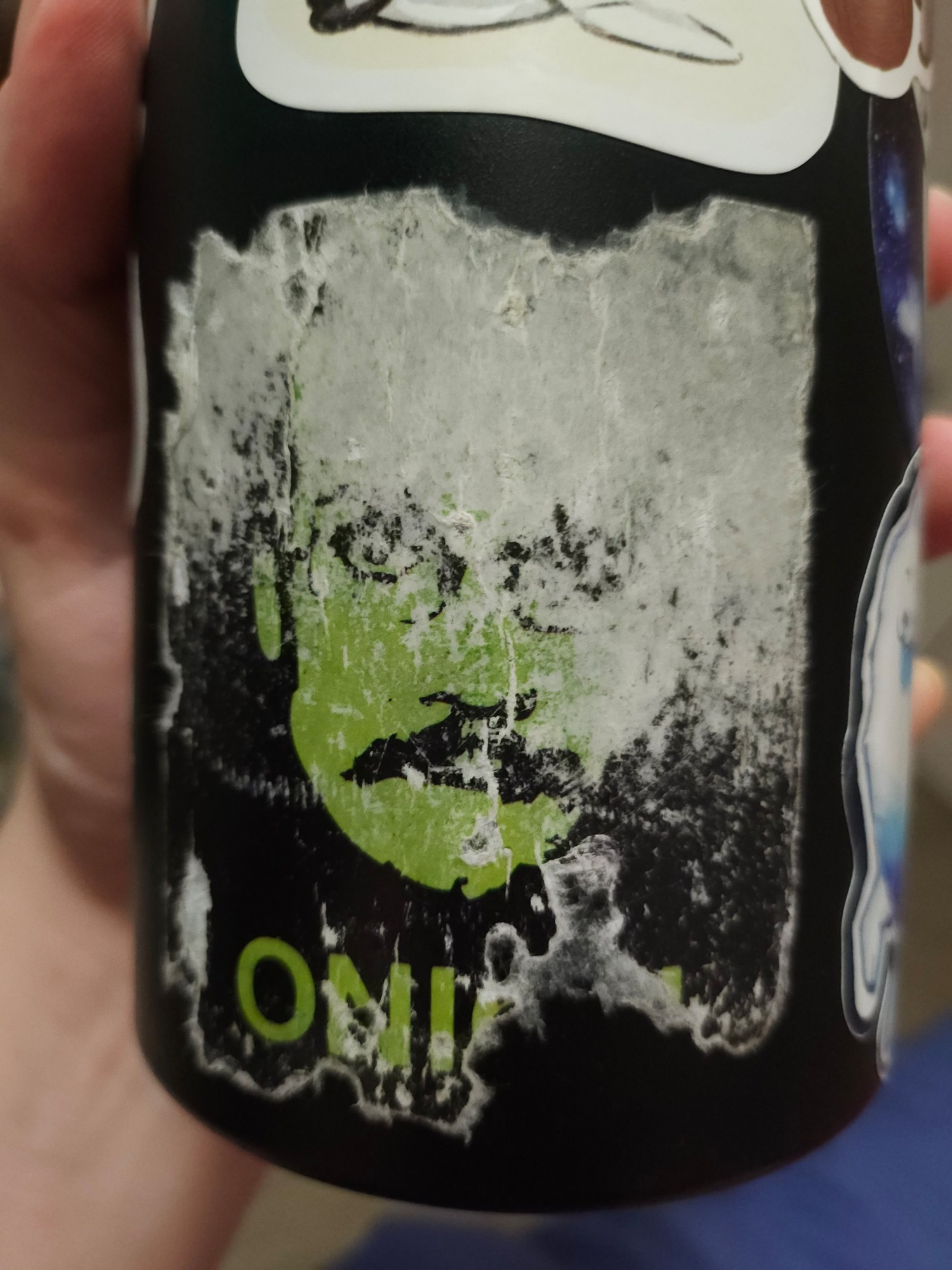 The bottom half of a metal water bottle, showing the state of my "Onion" Pizza John sticker. Originally, you could see Shrek Ears on his head, but they are long gone. The sticker is really not look good due to water damage.