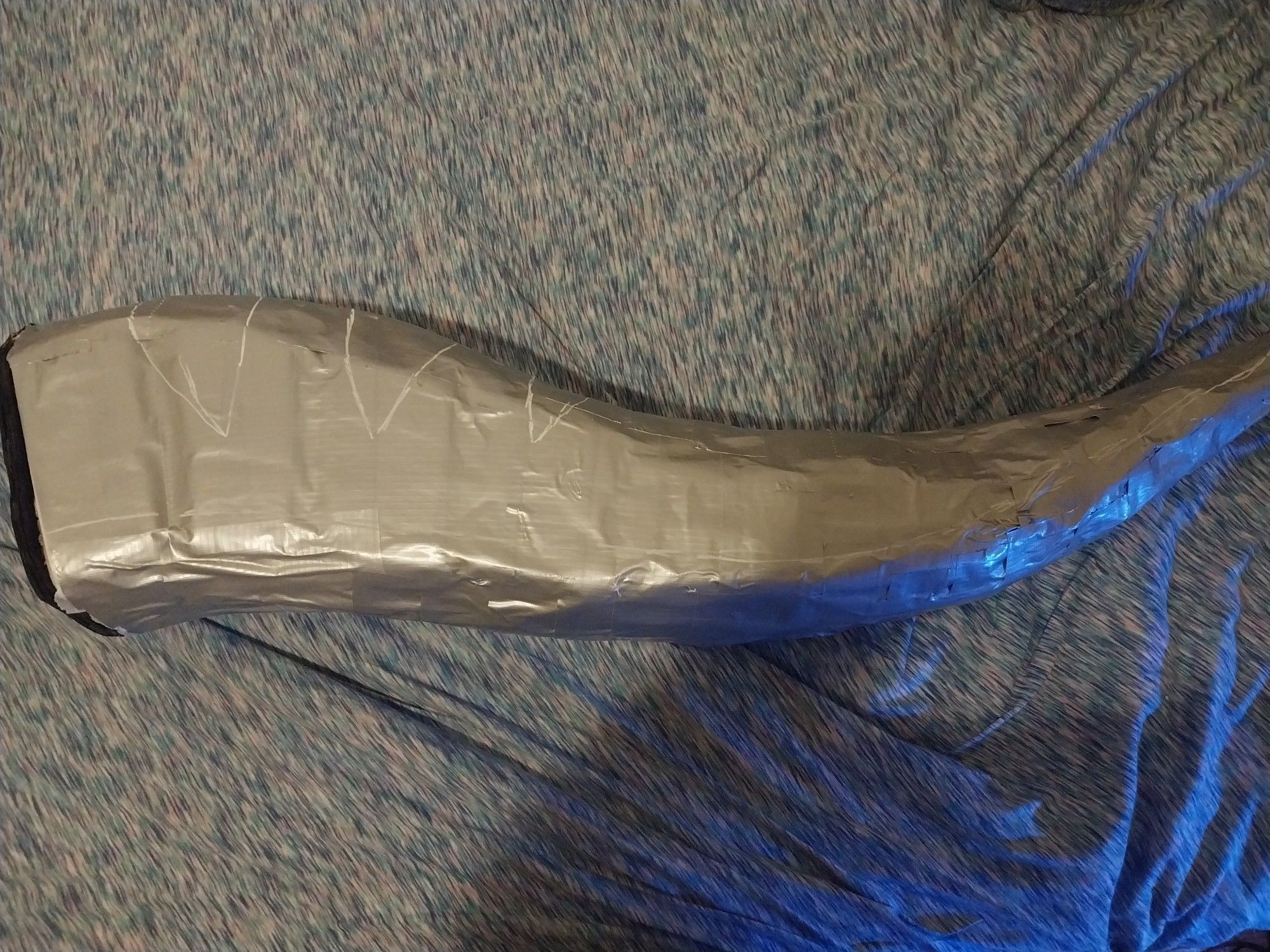 A fursuit tail base, covered in duct tape and marked with a white chalk marker to show the pattern.