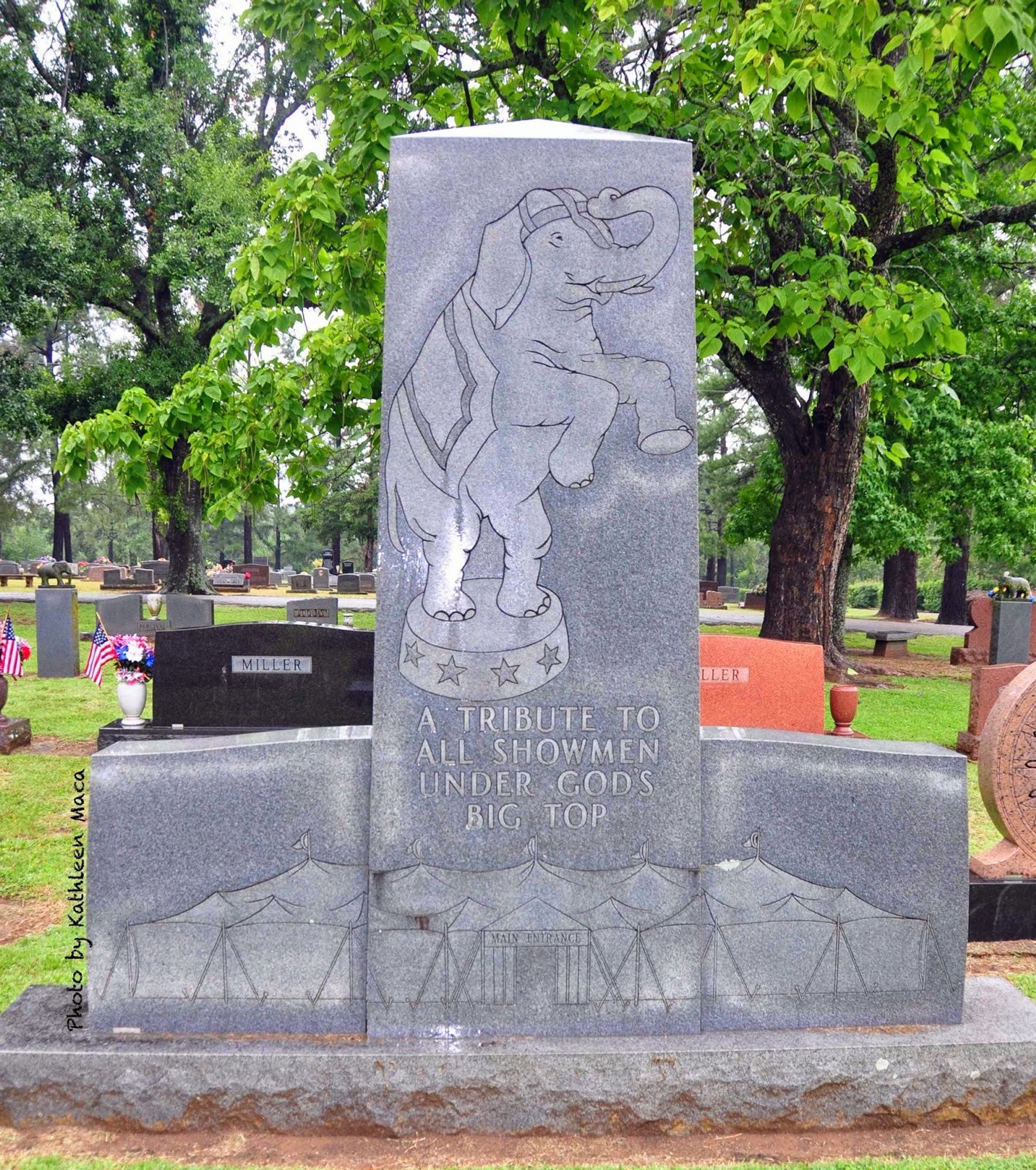 A large Showmen's Rest monument, featuring a performing elephant and circus tent, with the words A TRIBUTE TO ALL SHOWMEN UDNER GODS BIG TOP.