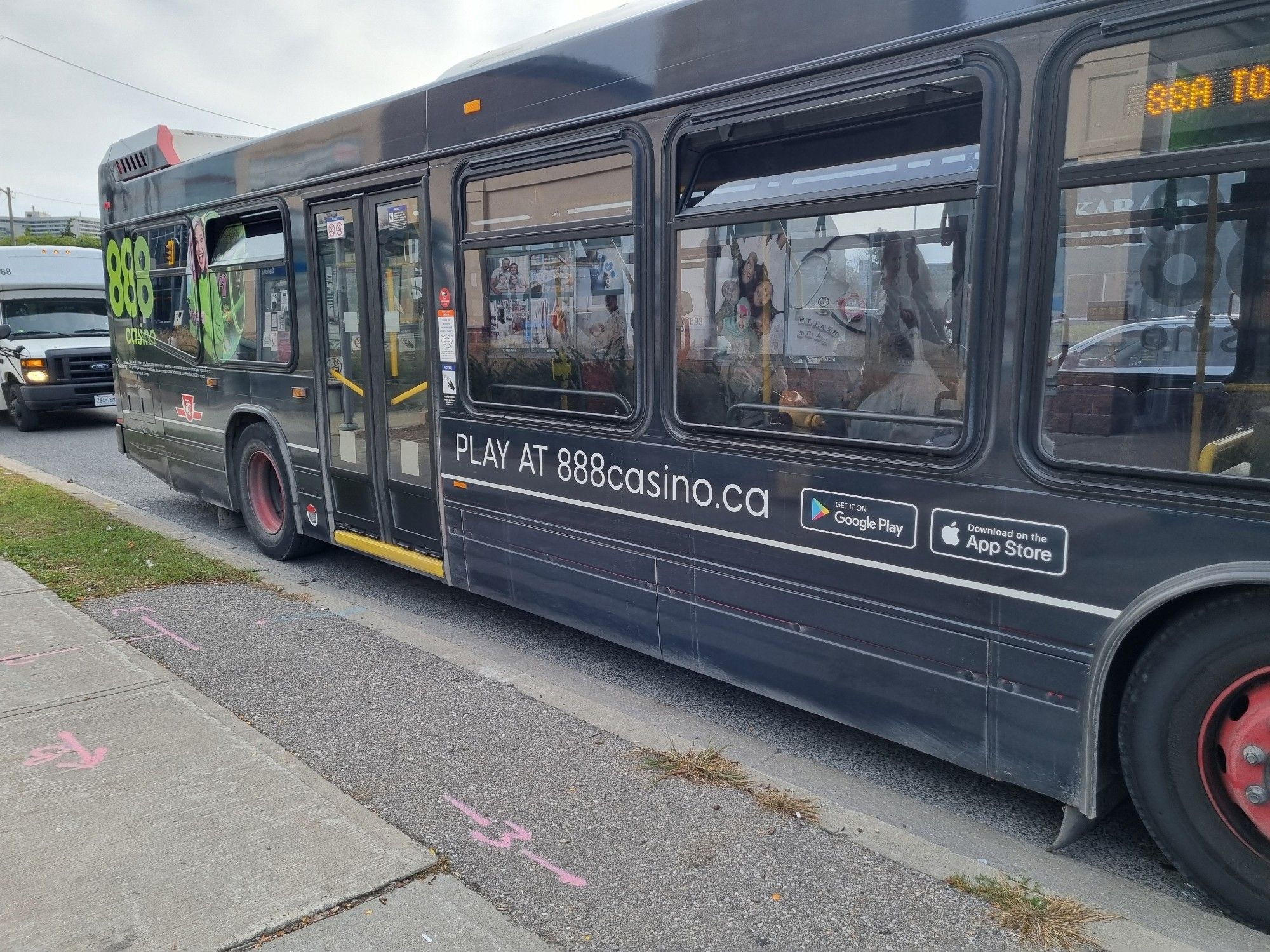 A Toronto bus covered with a complete wrap with an ad for an online casino.