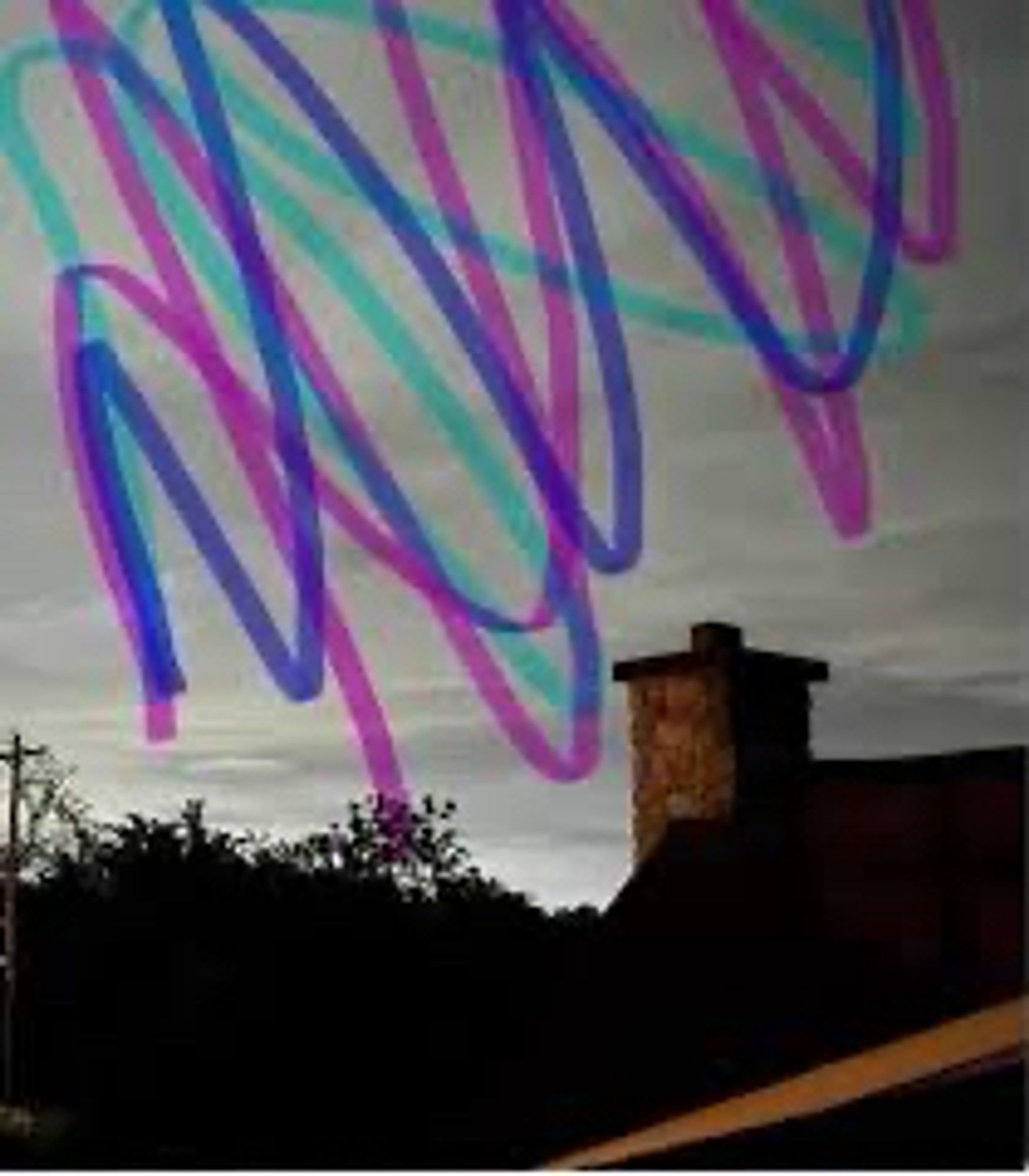 photo of an early evening sky over a rooftop. someone had drawn teal, purple, and blue marker ink smudged all over the sky. captured this image on google