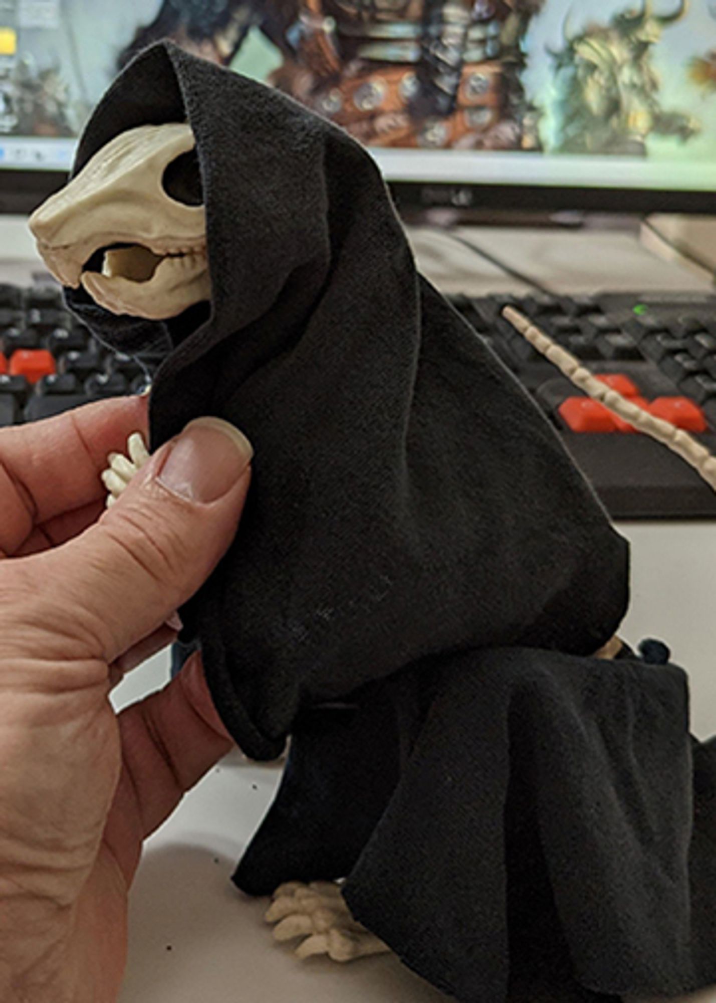 a small plastic rodent model draped in black cloth