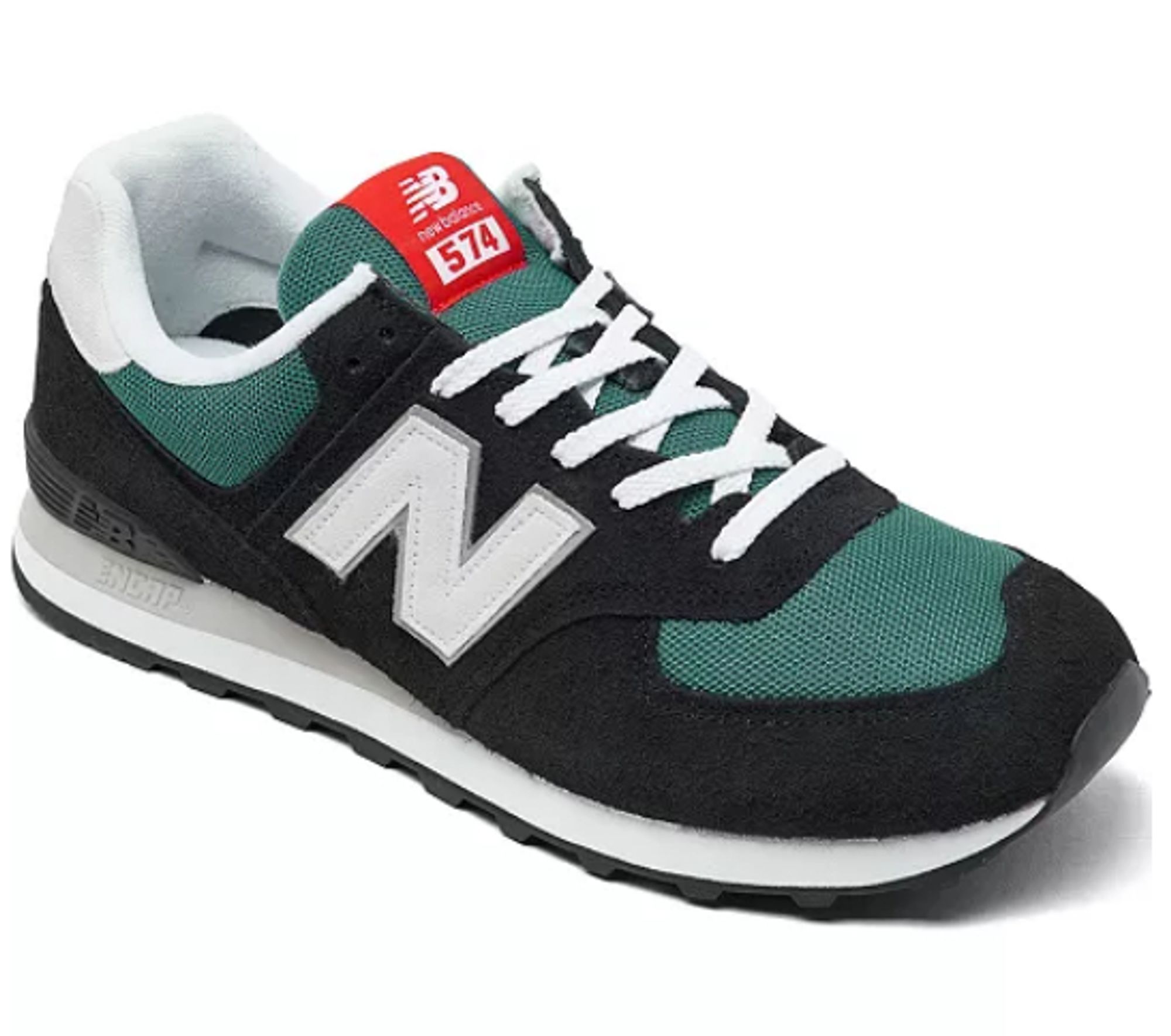 Picture of NB 574 shoe, it is mostly black suede with some dark green mesh and white accents, plus a red tag on the tongue.