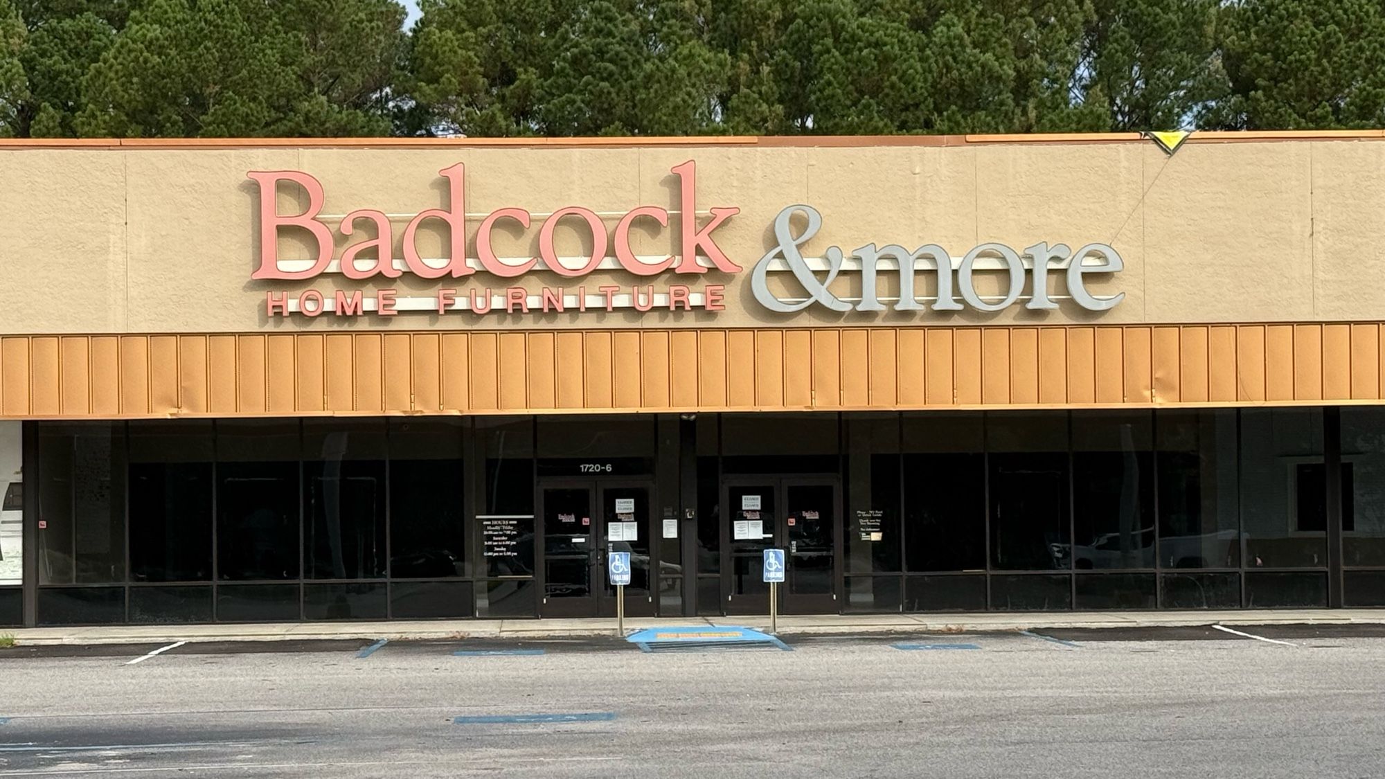 A strip mall store called “Badcock & more” (with “Home Furnishings” written below in much smaller letters.)