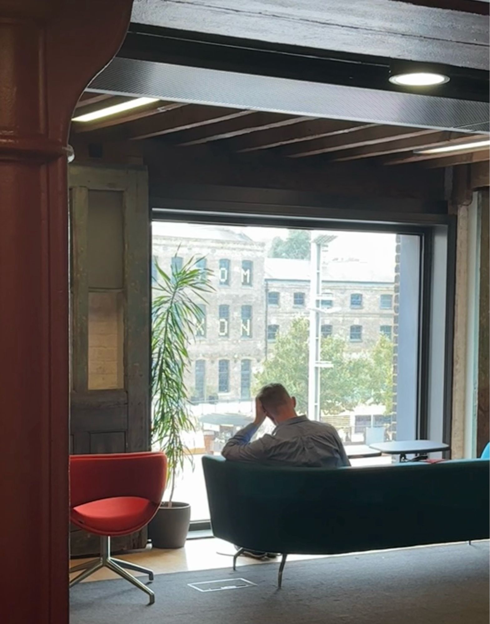 A student studying,  facing a library window, University of the Arts London