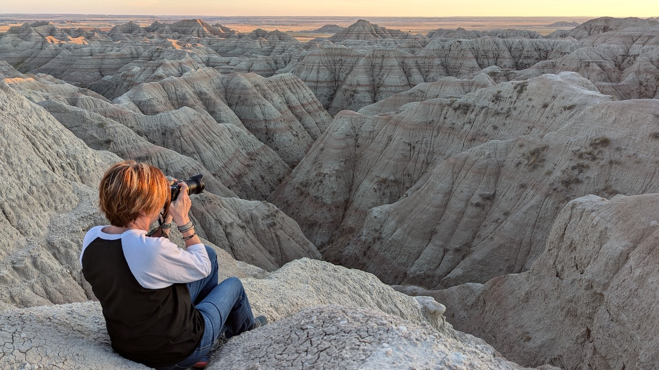 Karen Ruby of Dakota Imagery taking a photograph of the Badlands National Park. Photo taken by her Bryan Ruby.