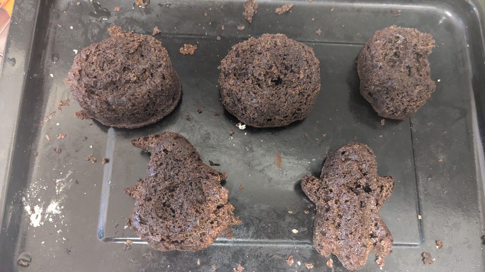 5 dark brown cakes generally in Halloween shapes. The details got stuck in the molds