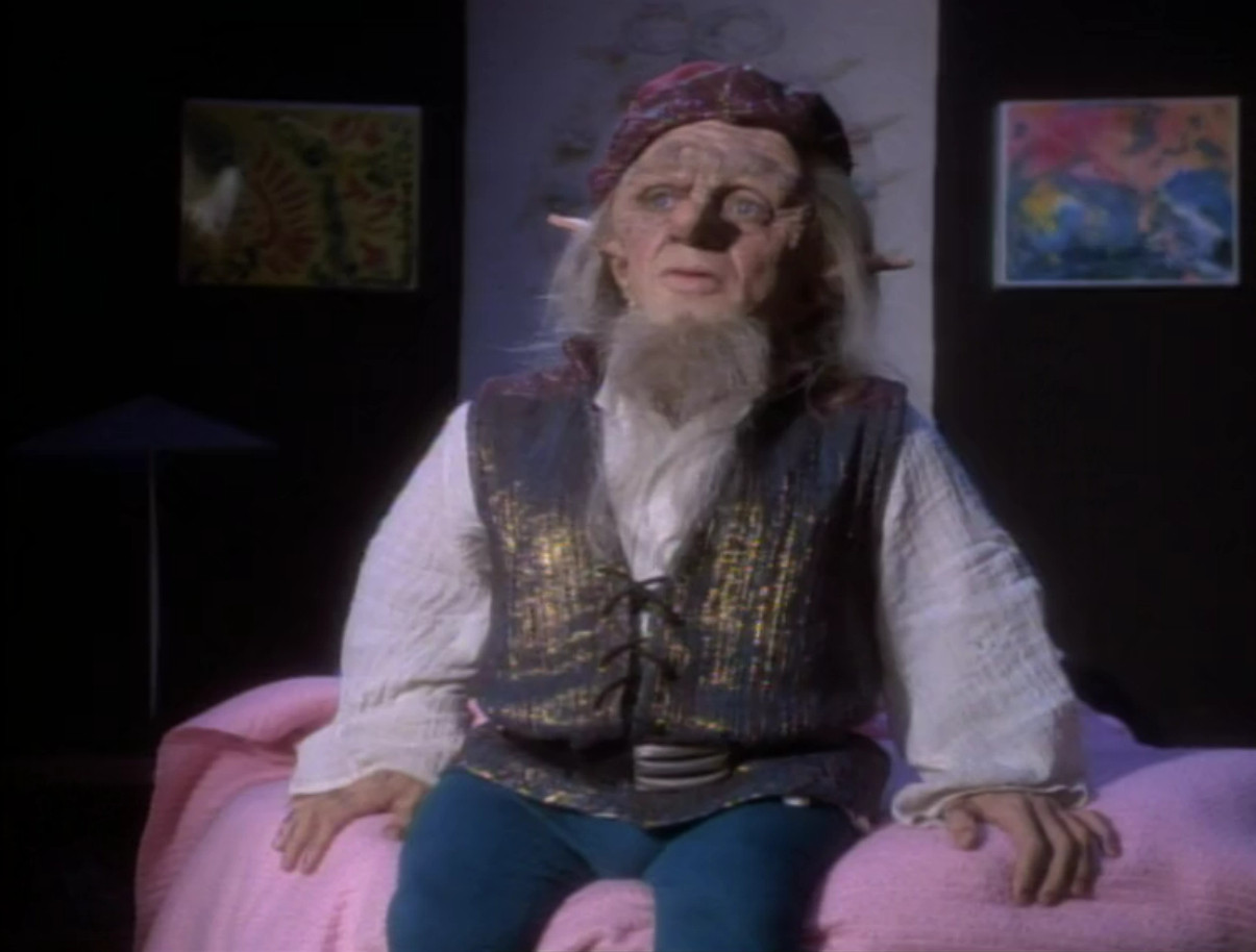 Rumpelstiltskin, sitting on Molly's bed.