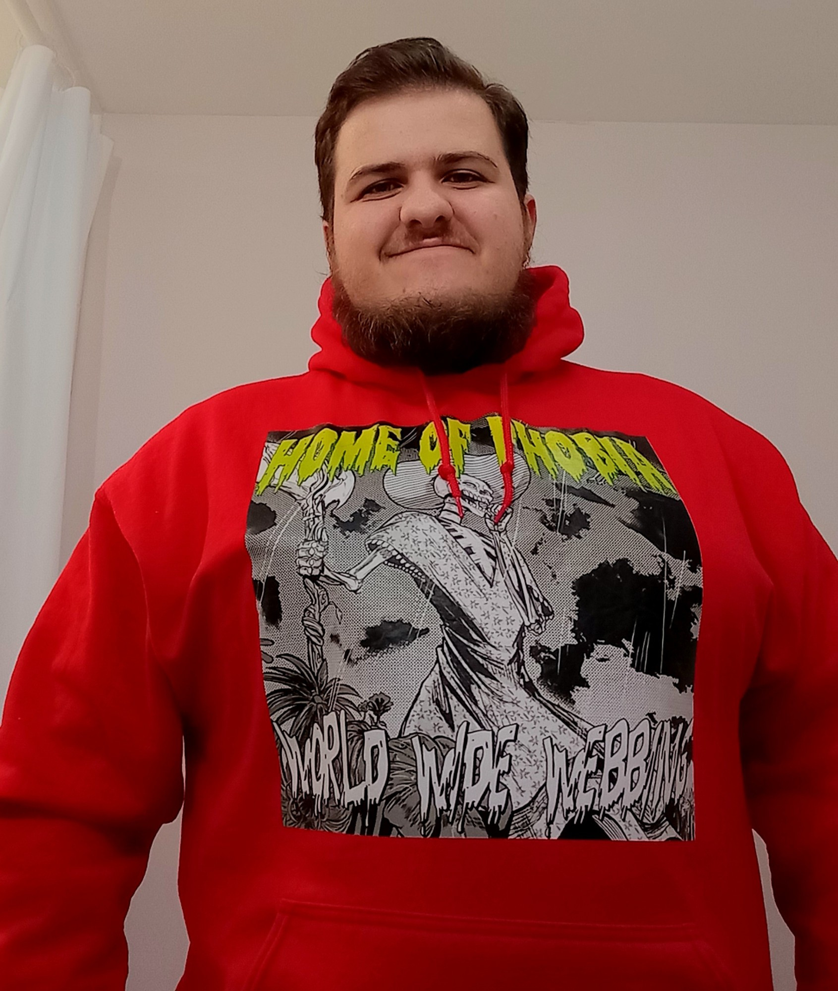 me wearing a red hoodie with the album cover for World Wide Webbing by Home of Phobia on it