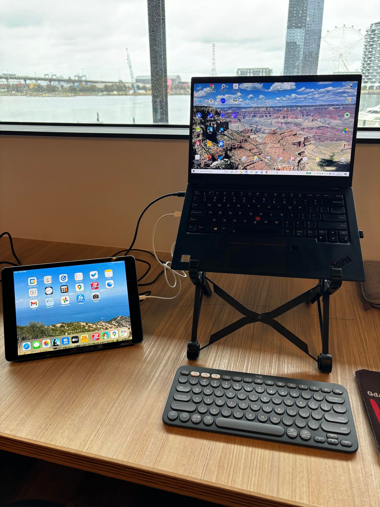 Laptop on riser, with an iPad propped next to it. 