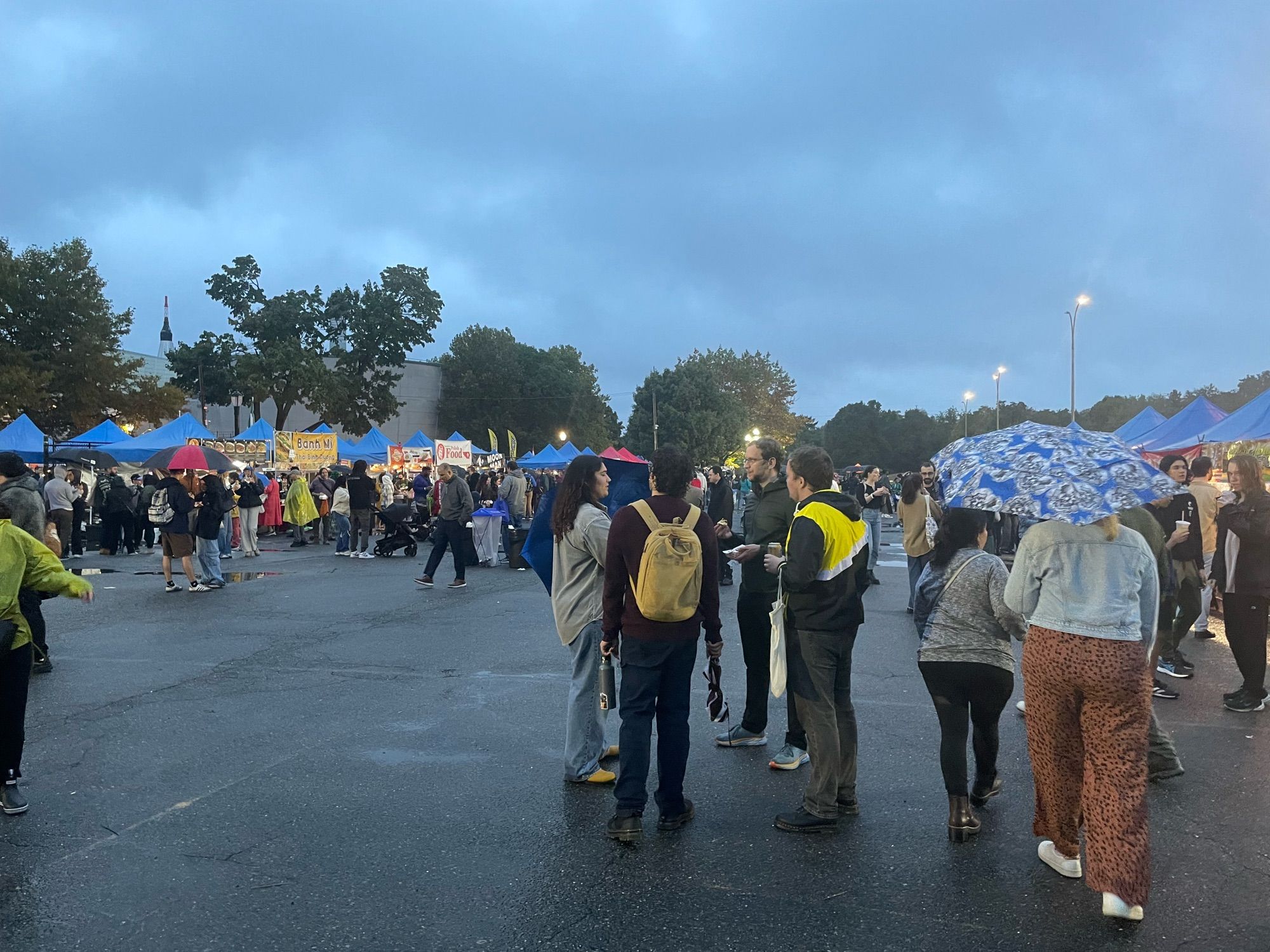 Grey sky, umbrellas up for rain, breathing room at around 6pm at Queens Night Market