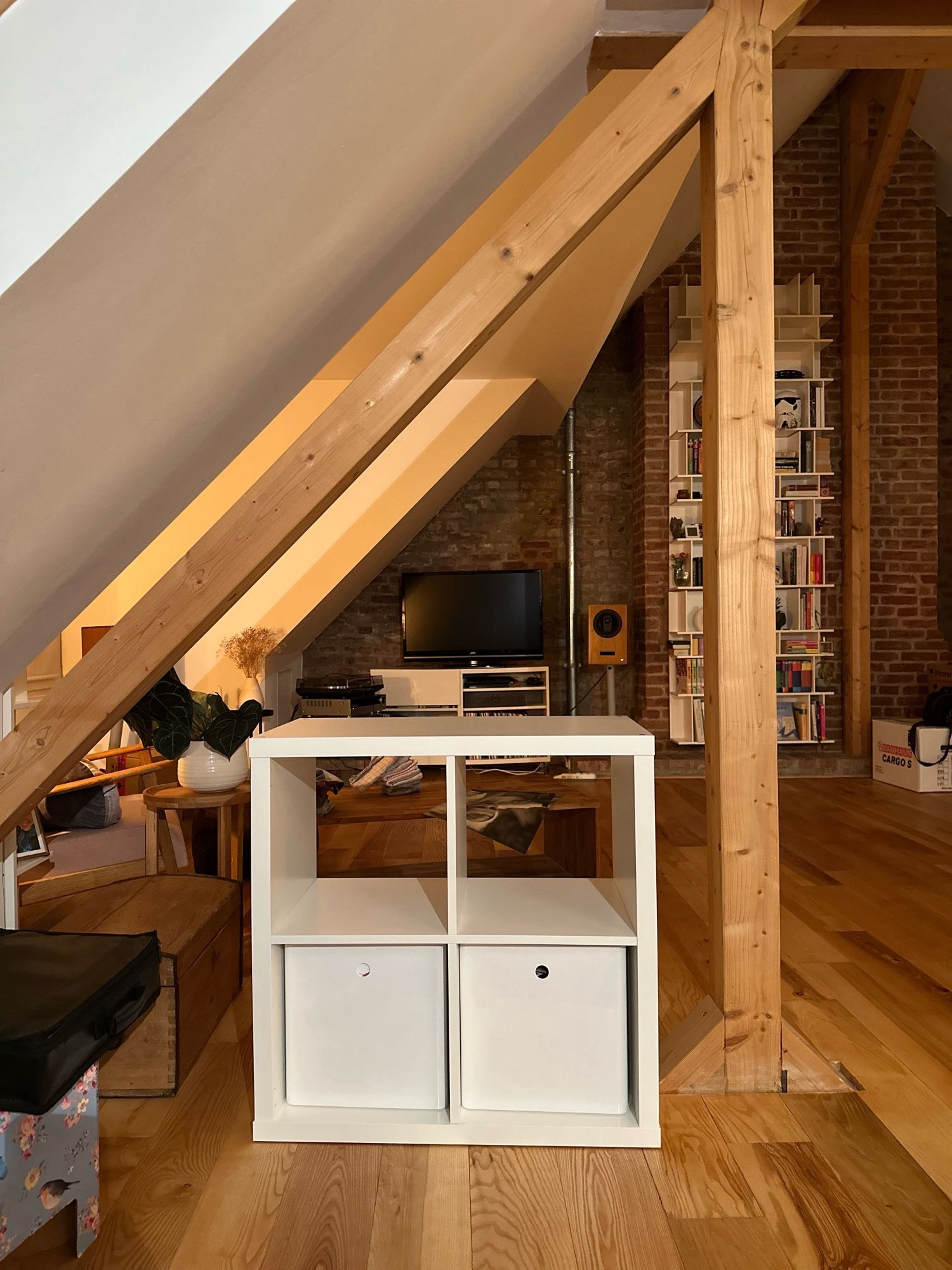 View in an attic apartment with shelves.