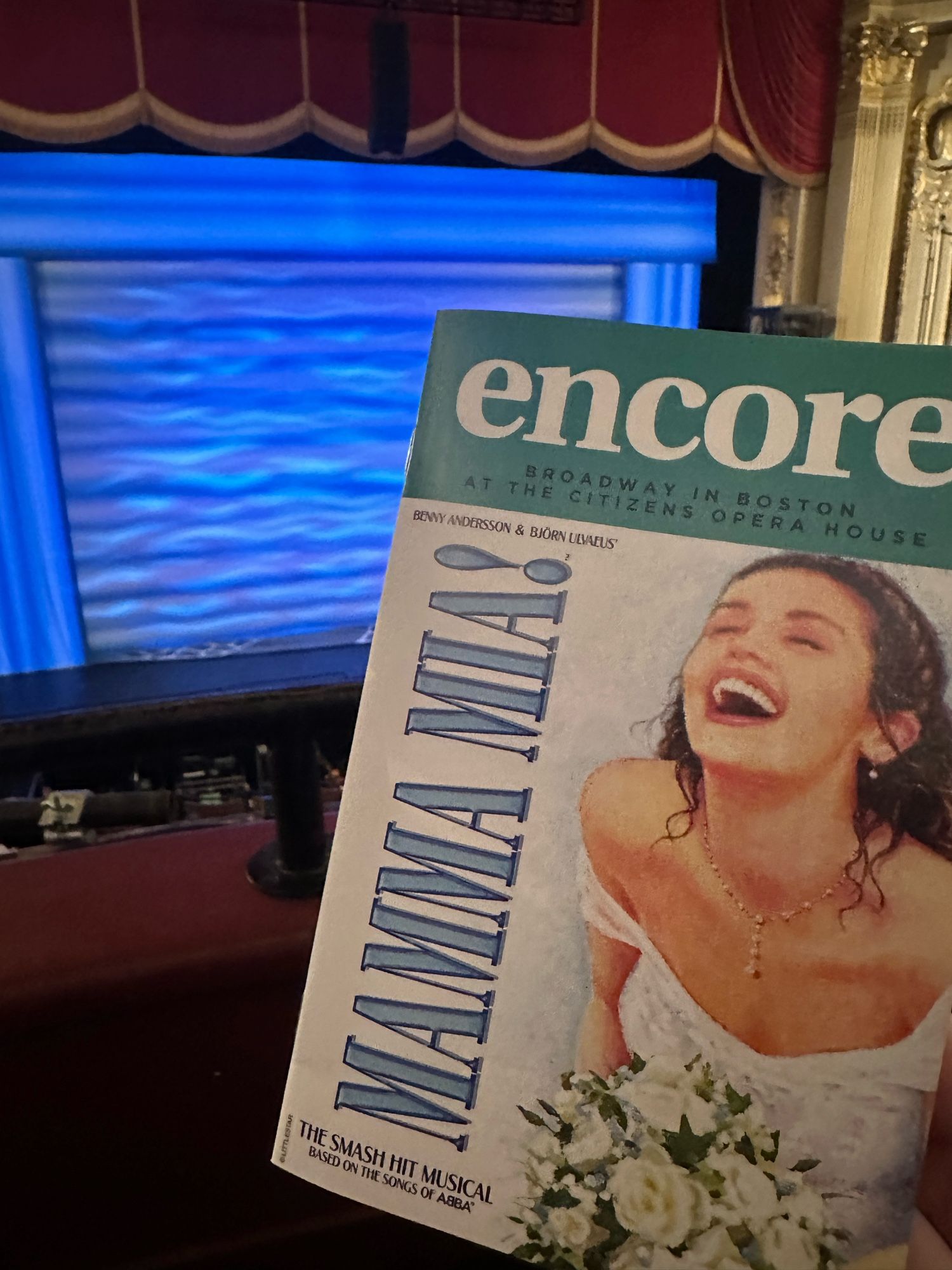 photograph of the encore program for the touring production of Mamma Mia, taken from the front row of the dress circle