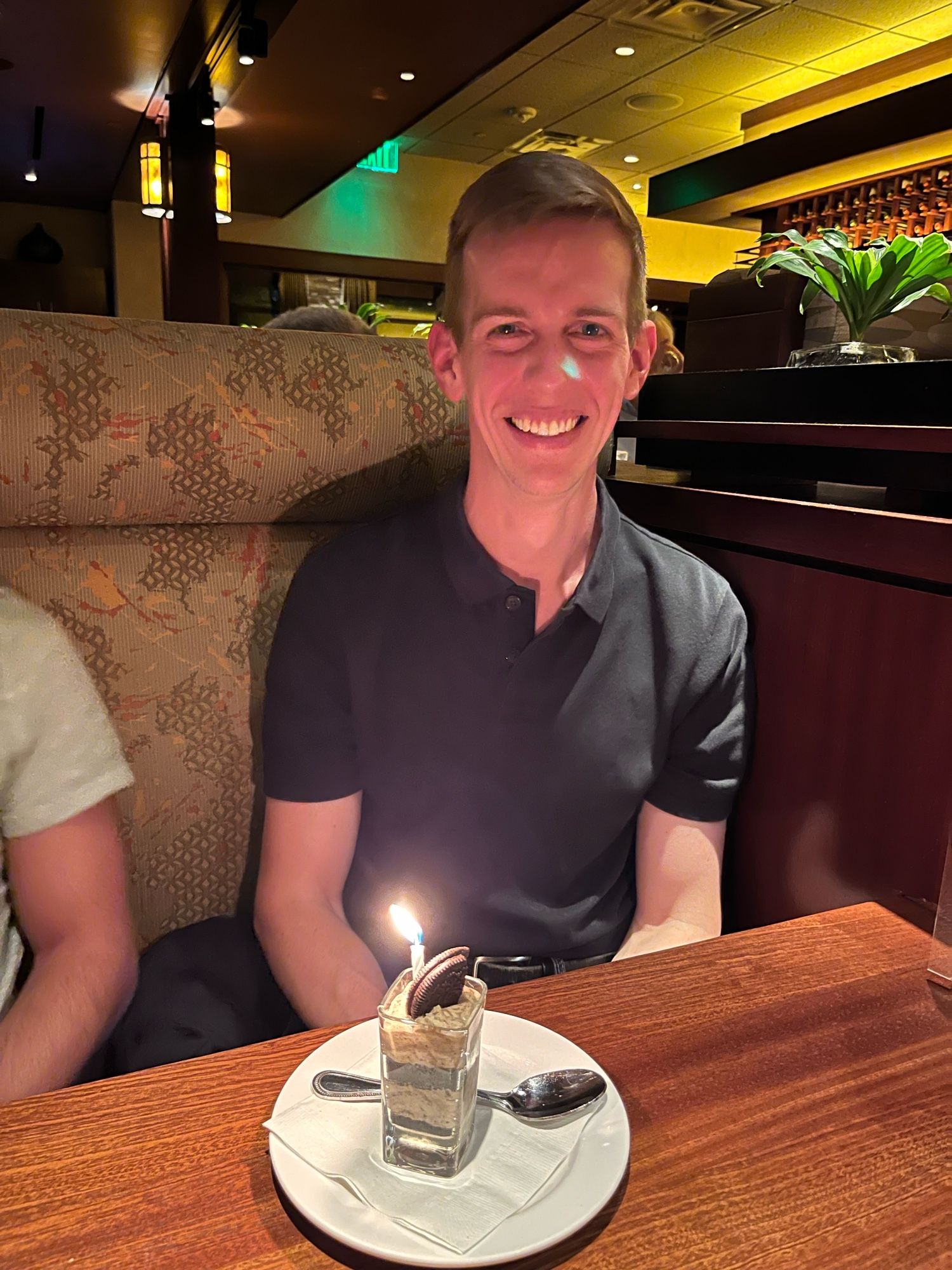 A homosexual celebrating his birthday at dinner with his husband and very good friends. 