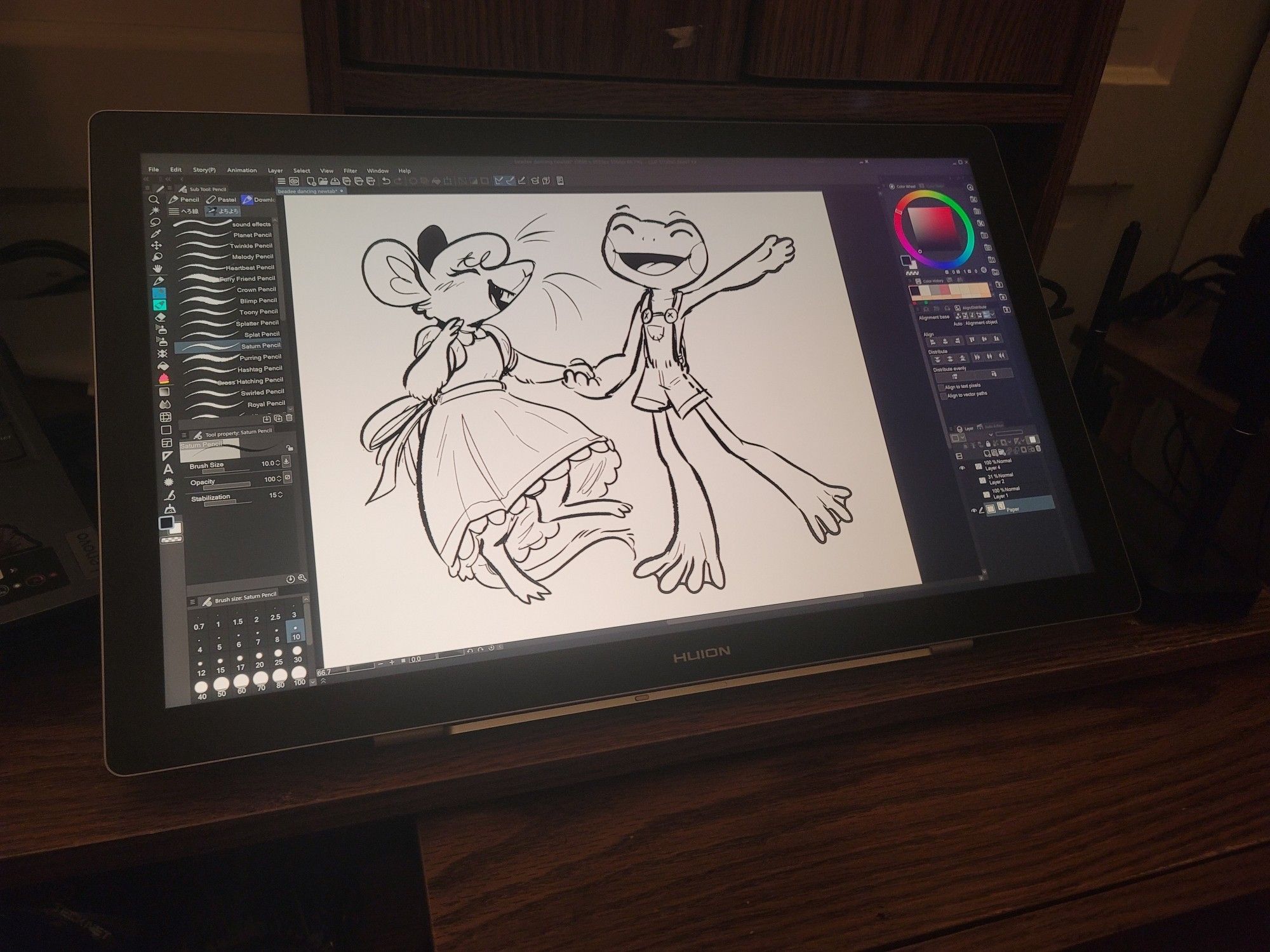 A photo of the same drawing on the screen of a huion kamvas pro 19, in Clip Studio Paint. The tablet rests on a wooden desk