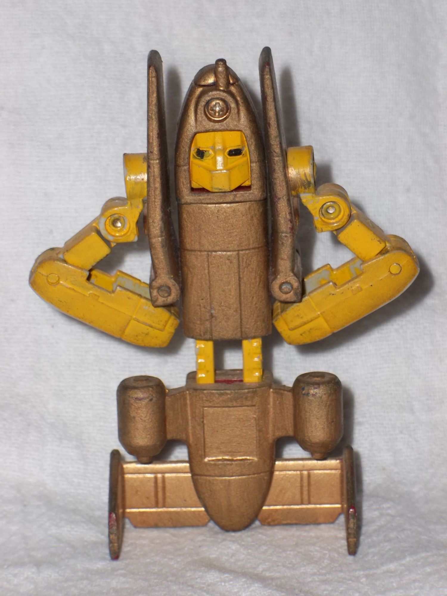 A Transformers G1 Powerglide action figure, customized with a gold and yellow color scheme, in robot mode.