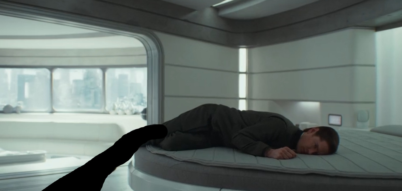 Syril Karn on the bed, his legs extended to a ridiculous degree