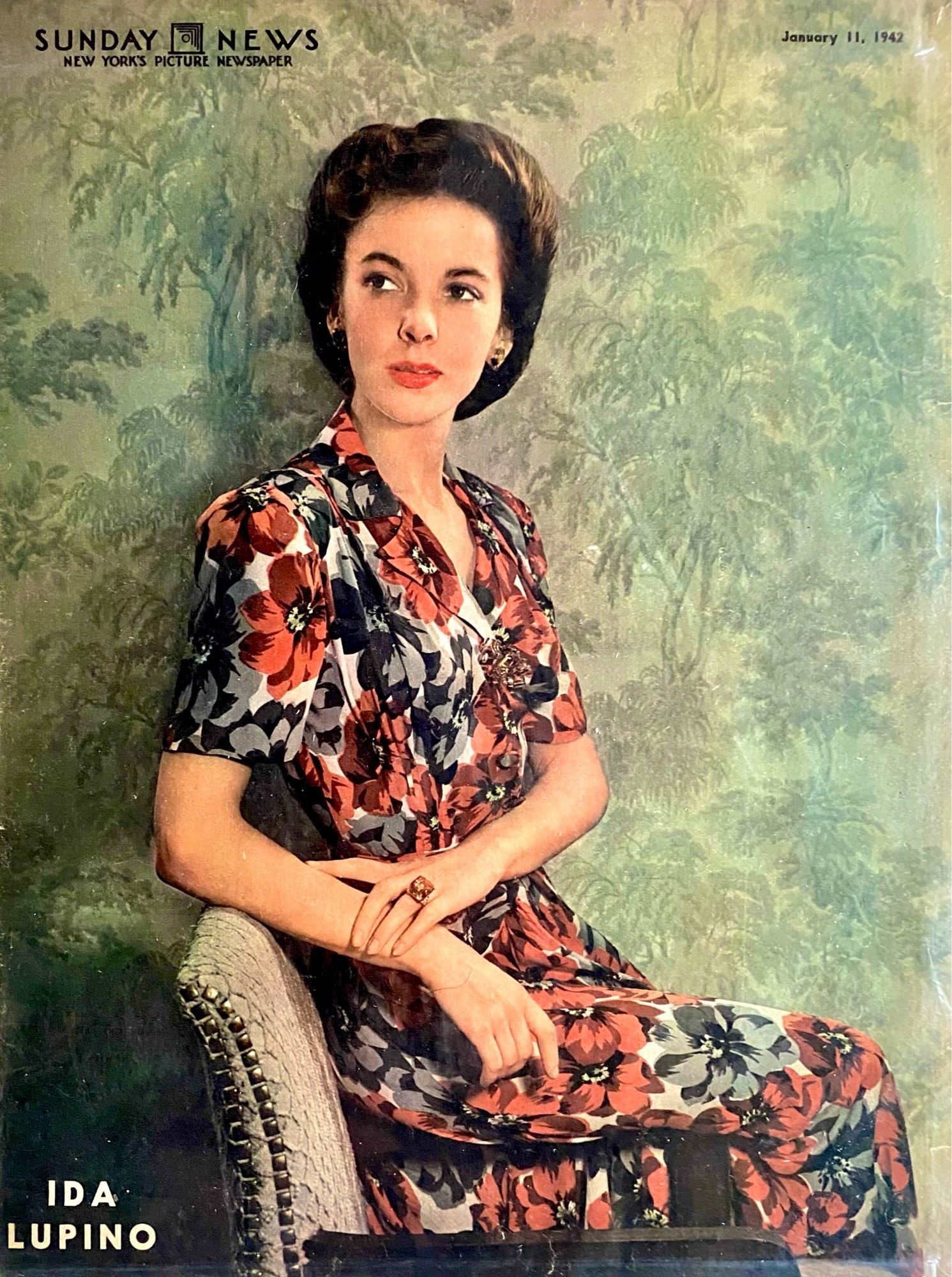 Color portrait of Lupino in black, gray and Rex floral print dress.