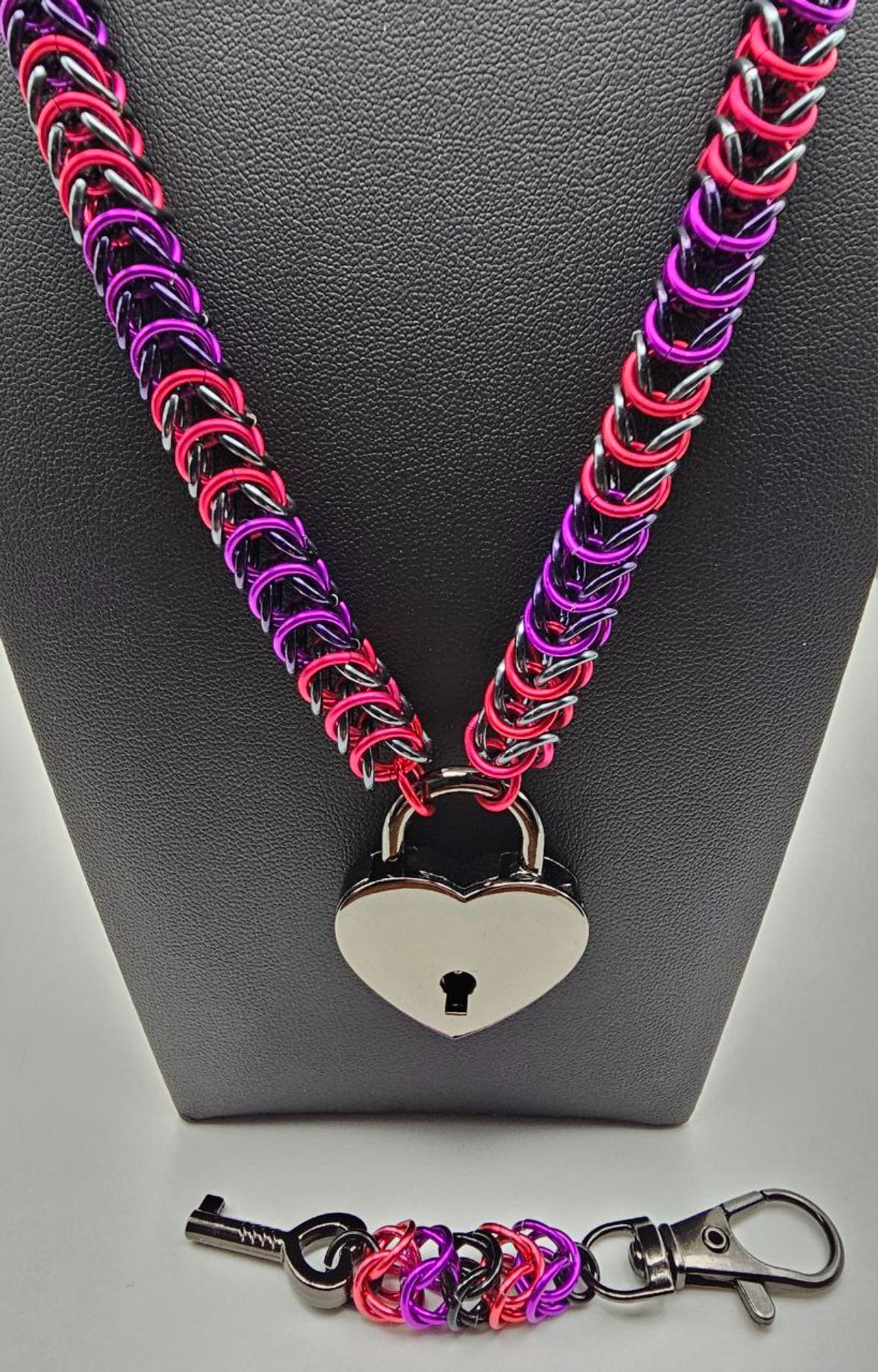 Box weave chocker or collar with purple, fushia, and black rings with keychain