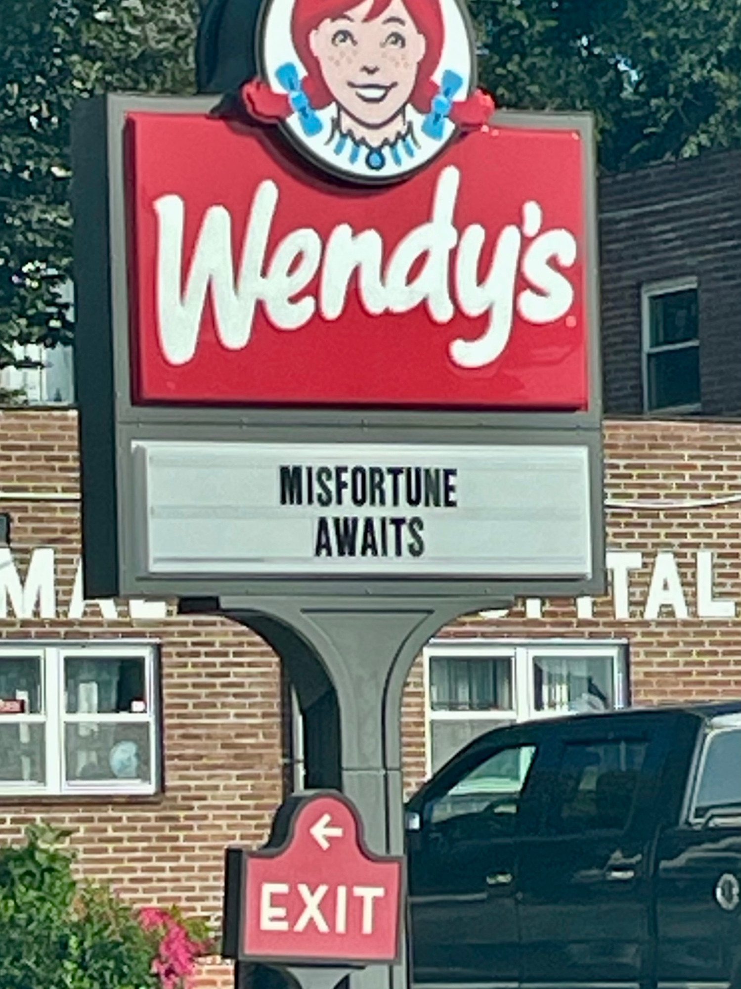 A Wendy’s sign that says “Misfortune awaits” 