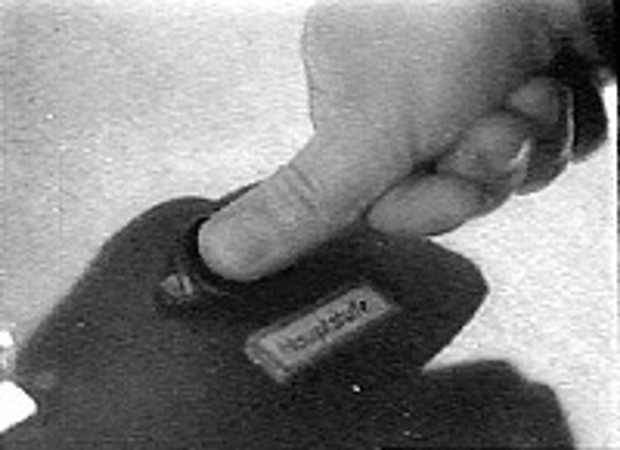 A black and white film still of a man pushing a button labeled Haupstufe! (Main stage ignition of a rocket)