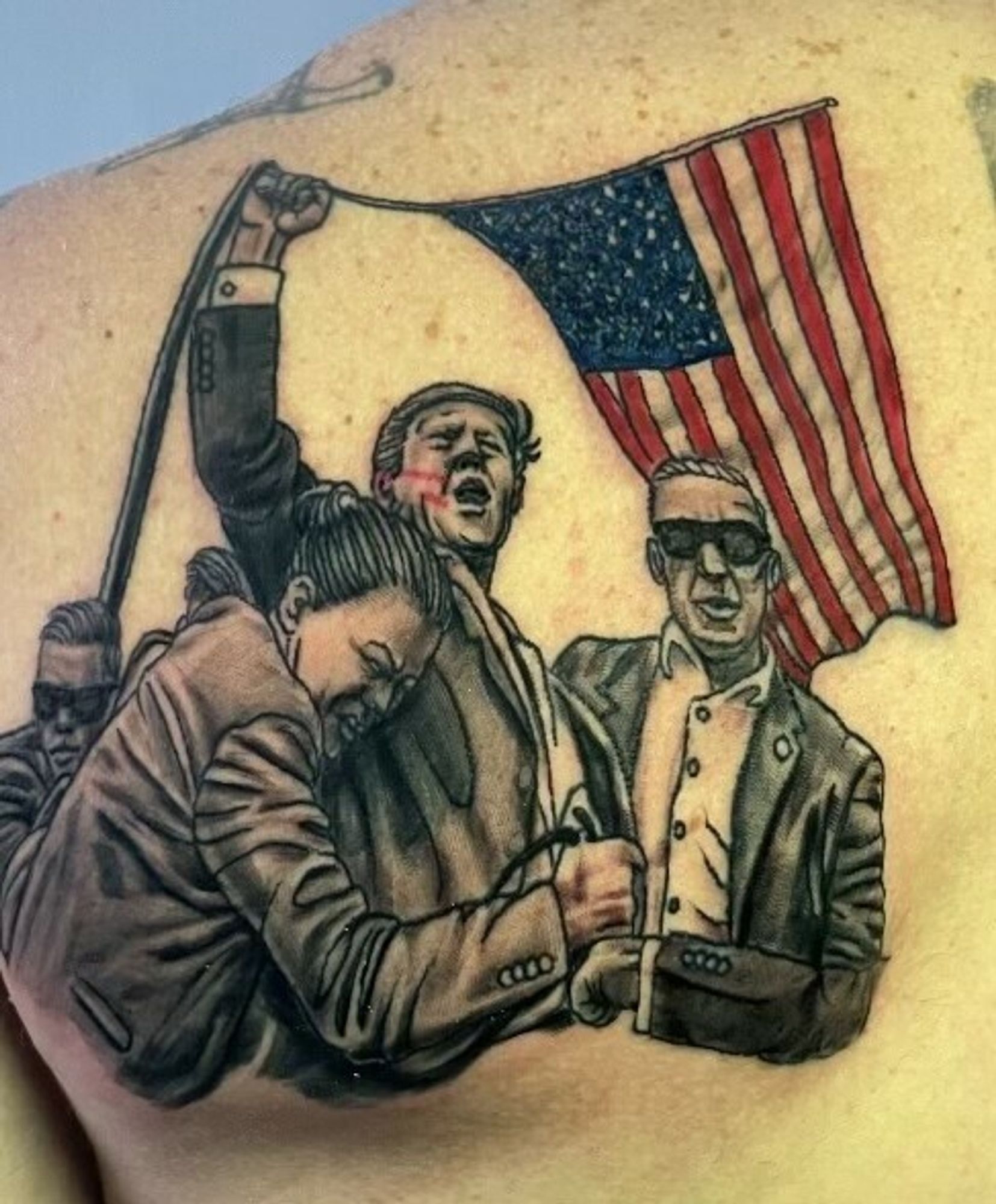 a tattoo of the fist-in-air photo from the assassination attempt.