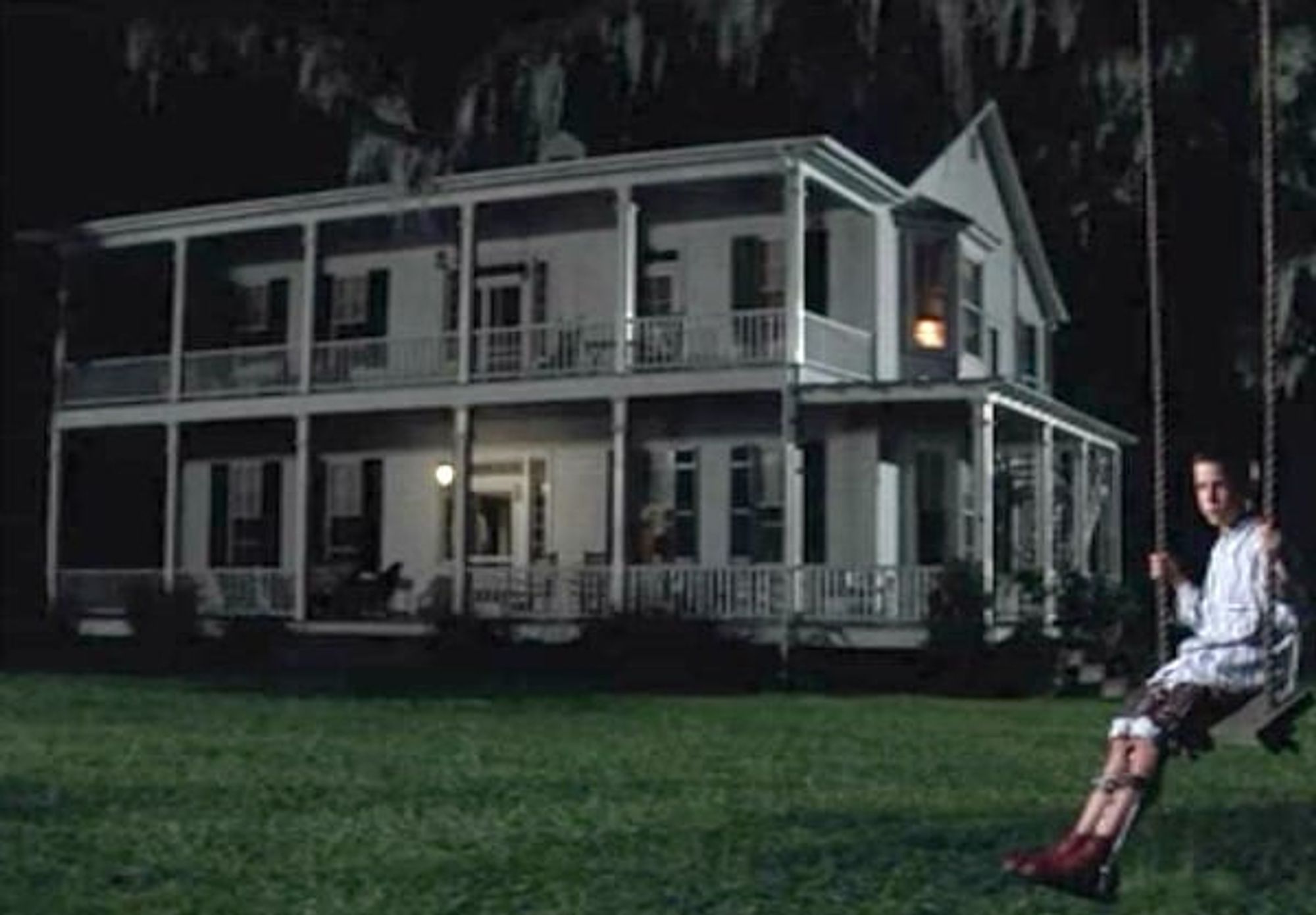 A picture of Forrest Gump's house from the movie -- it's a white, two-story Victorian house with a wrap-around veranda on both levels.