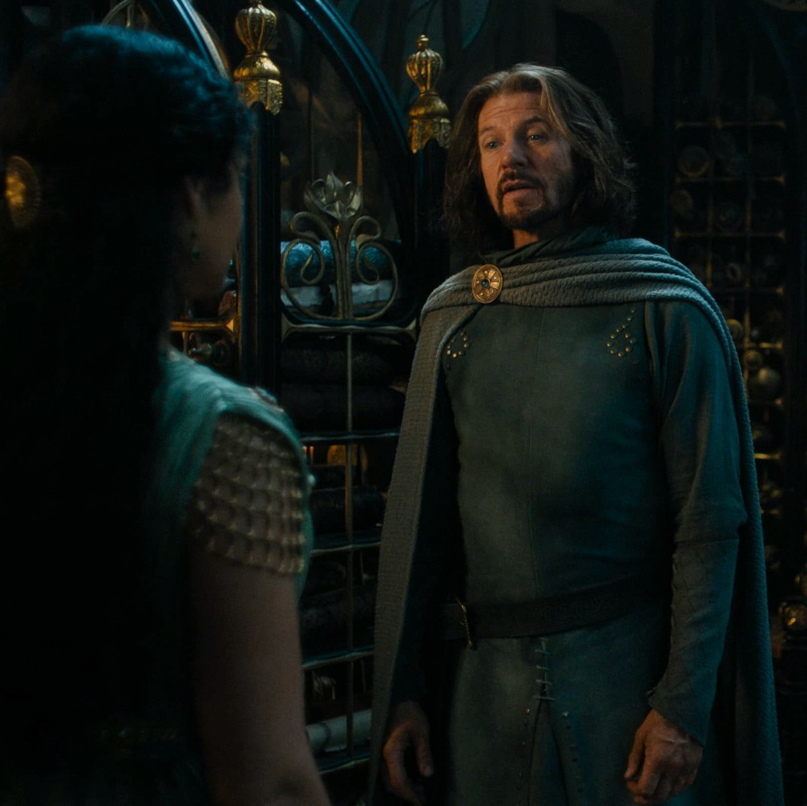 a screenshot of lloyd owen as elendil in the rings of power season 2 episode 8 confronting míriel as she indicates her unwillingness to leave with him.