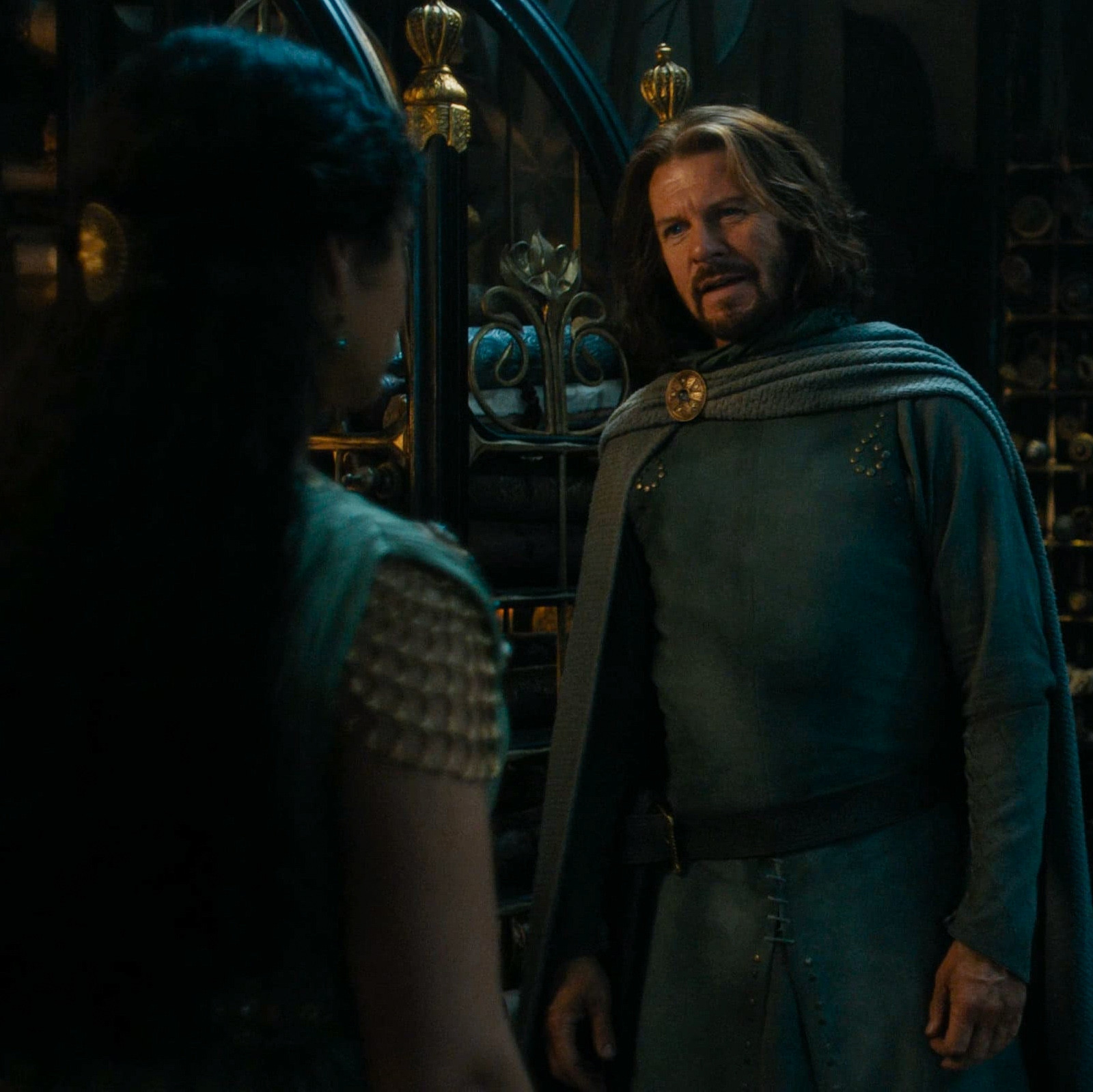 a screenshot of lloyd owen as elendil in the rings of power season 2 episode 8 confronting míriel as she indicates her unwillingness to leave with him.