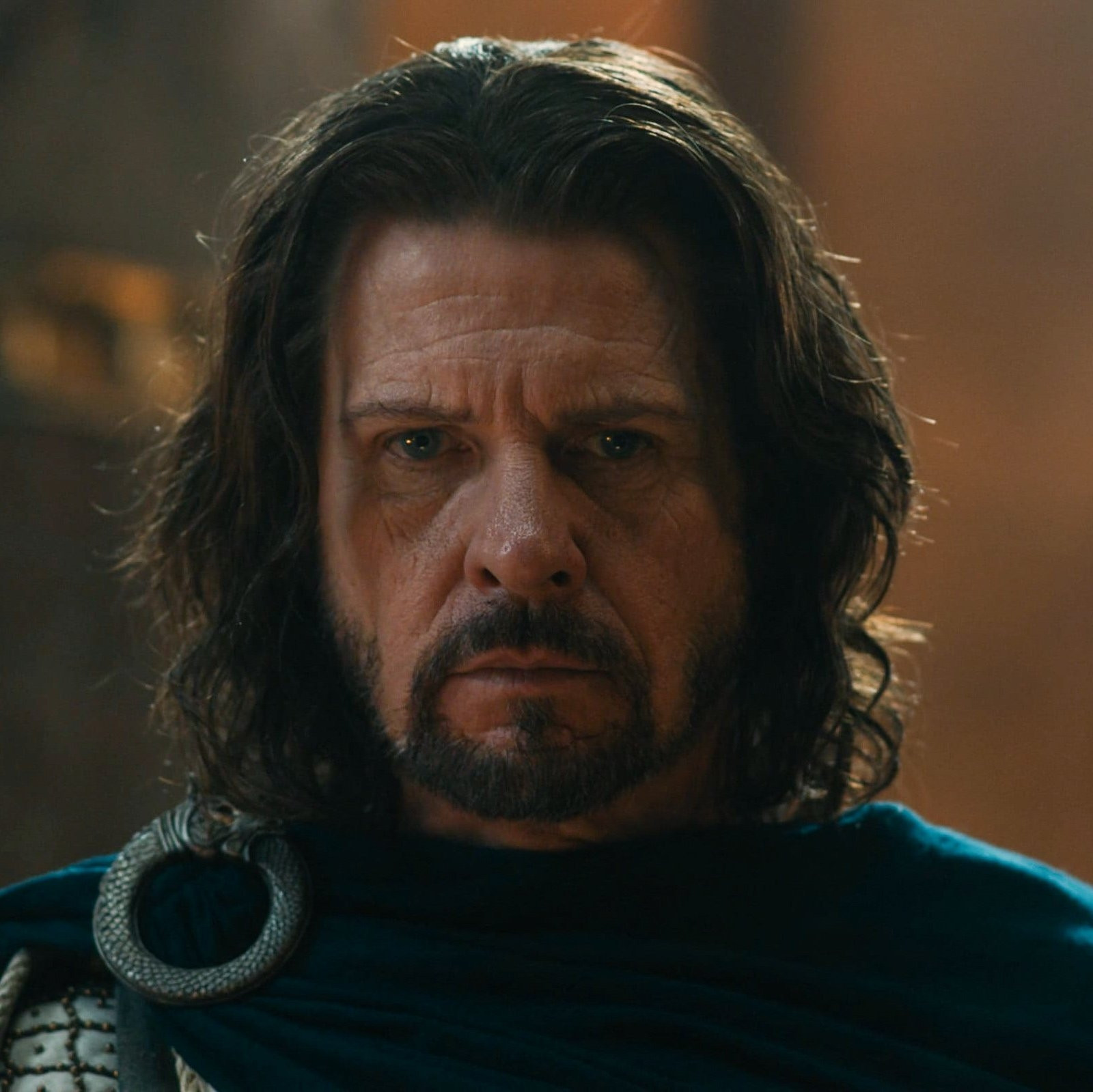 a screenshot of lloyd owen as elendil from episode 2.03 of The Rings of Power.