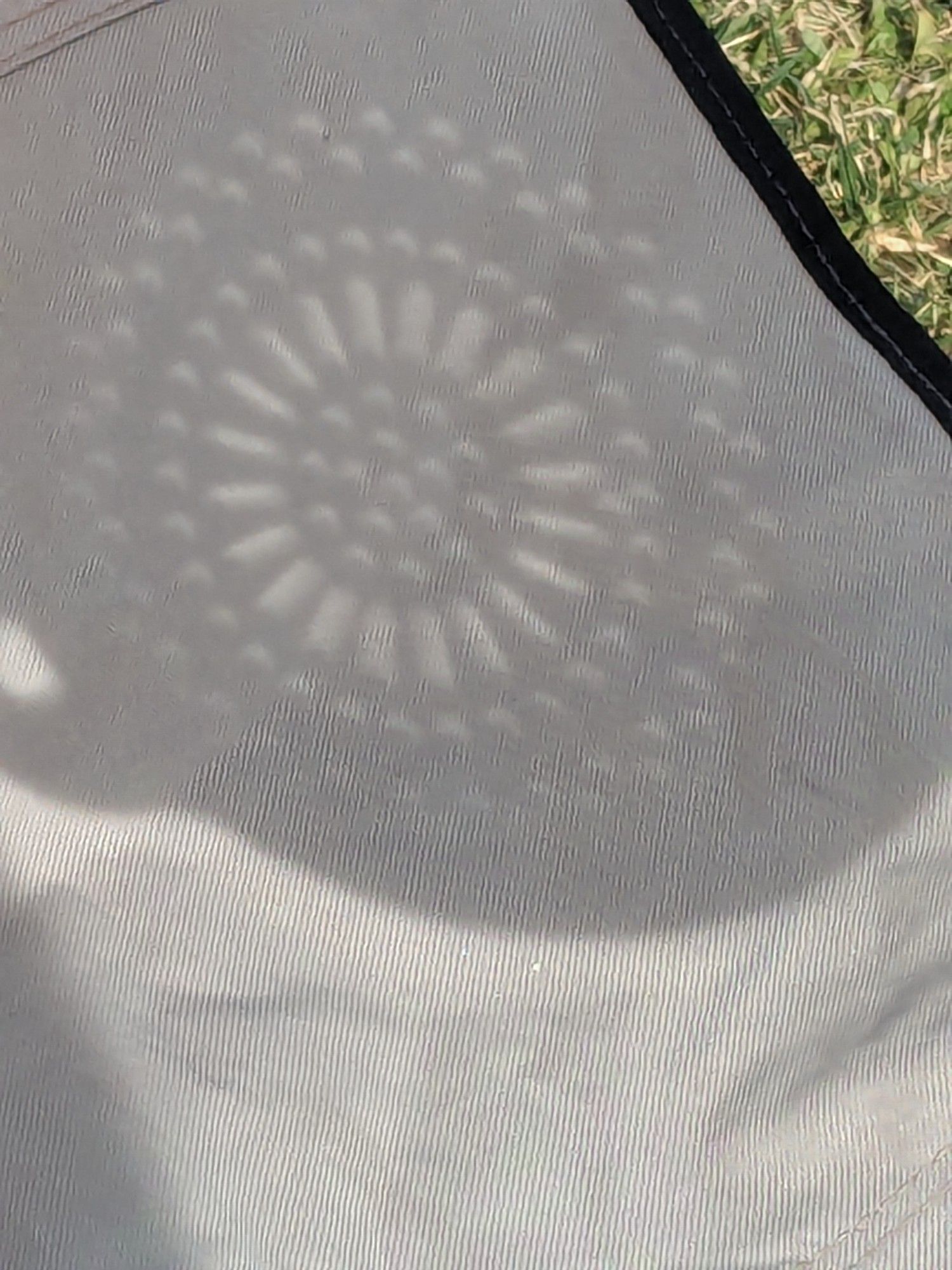 Shadow cast from collander; each circle of light has a crescent shape