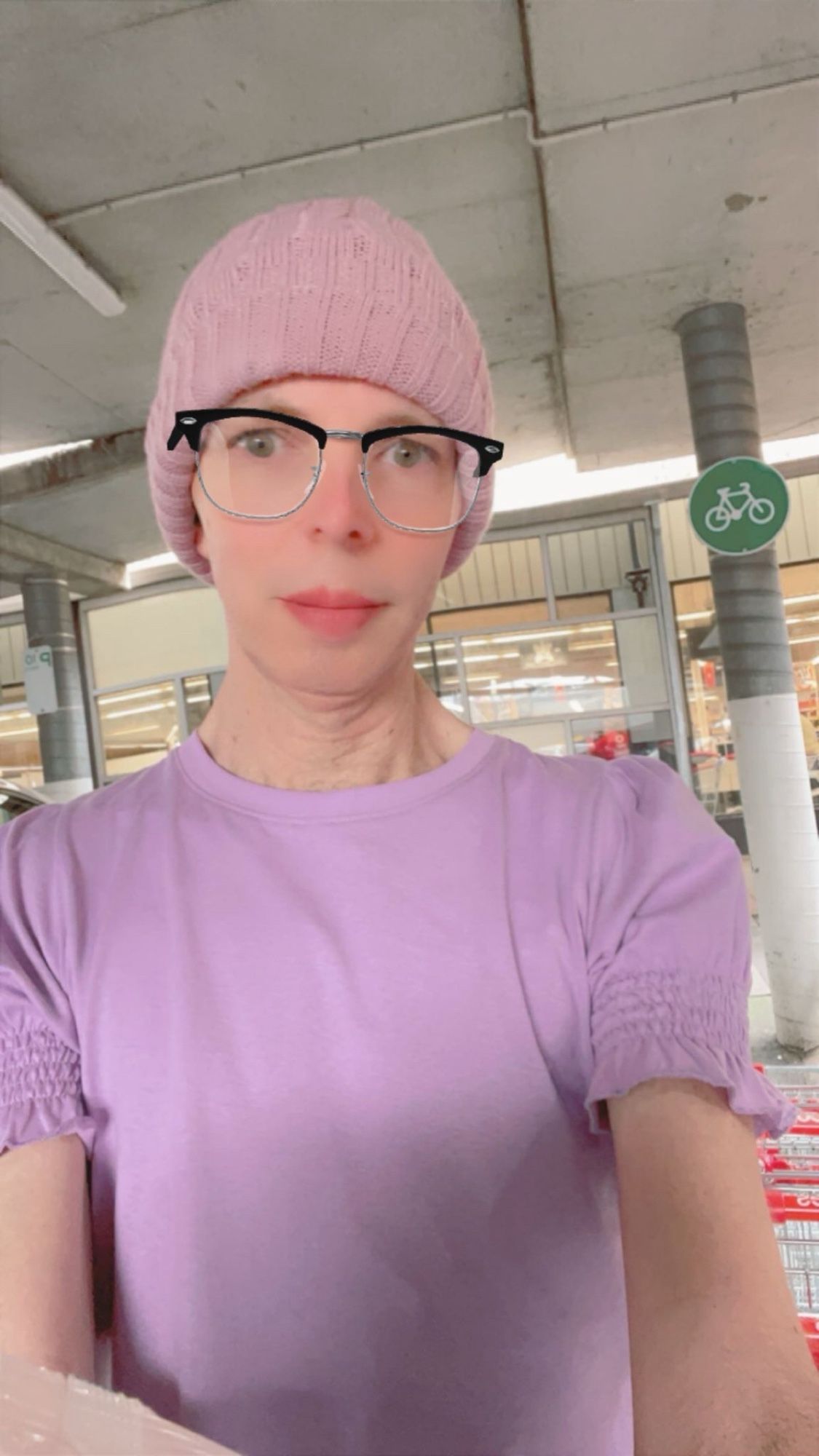 Crossdresser in a friily sleeved lavender top out shopping.