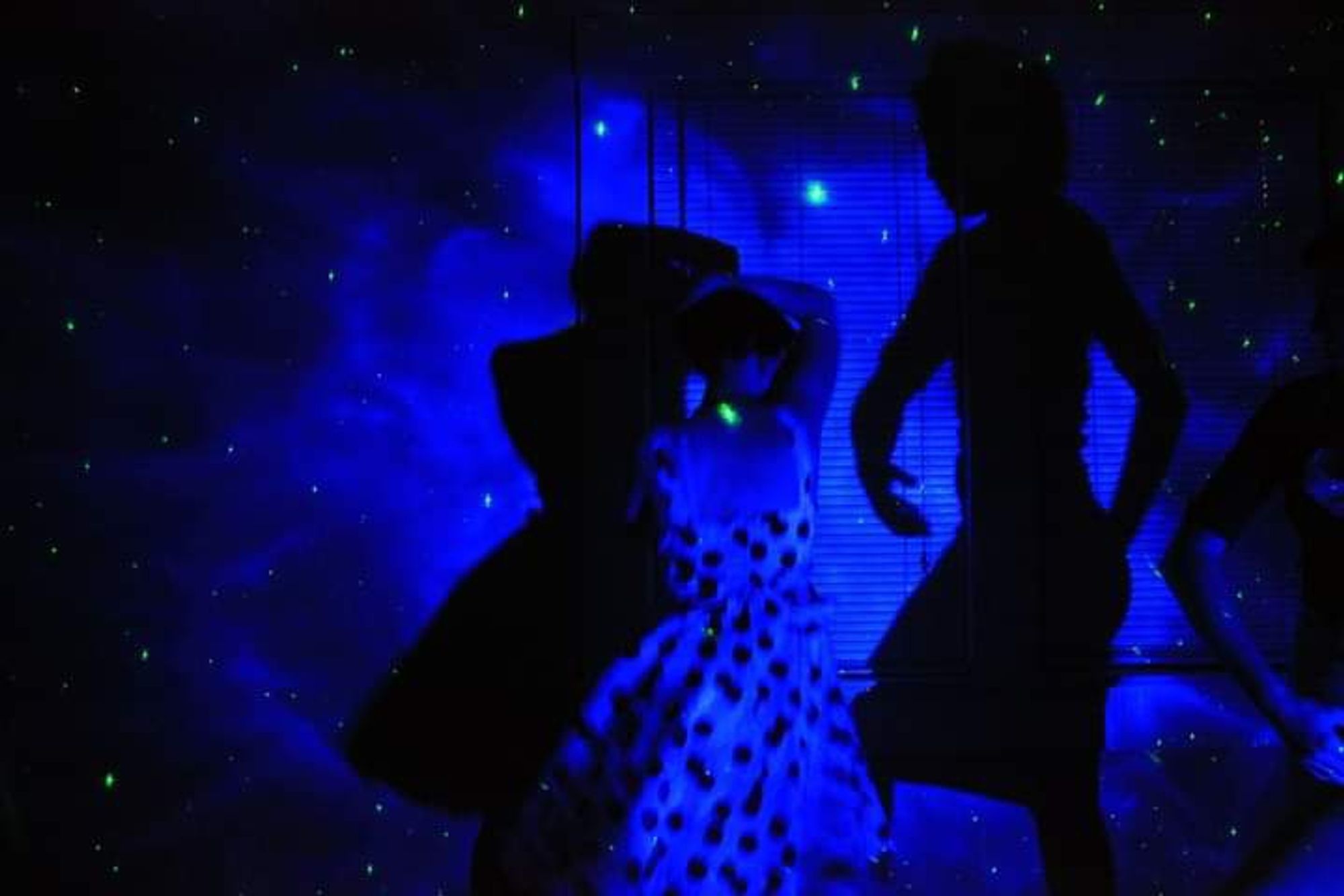 Dancing in a black light room in a pin up dress.