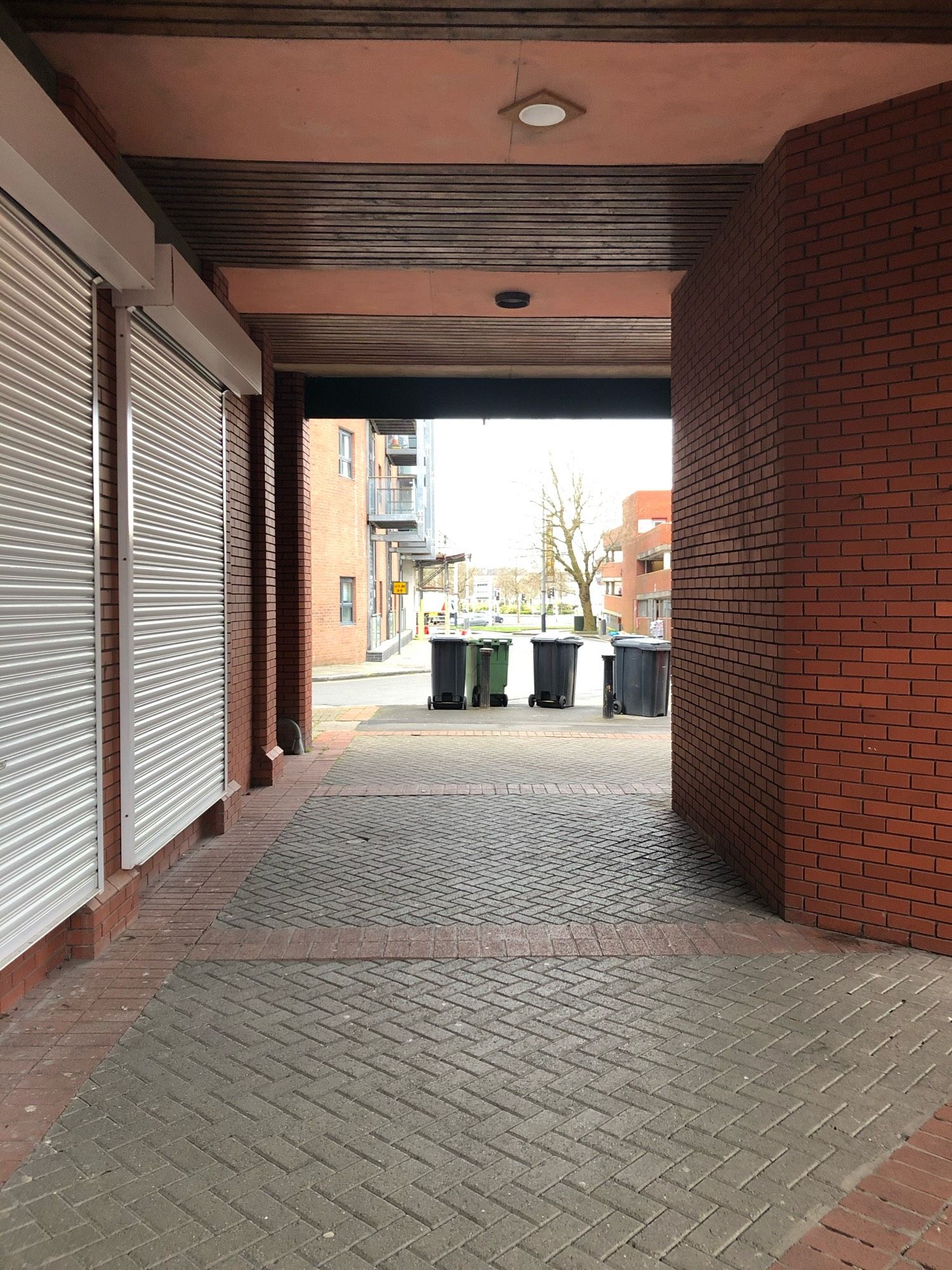 A covered walkway in the red-brick open-air St. David’s Shopping Centre in Swansea.