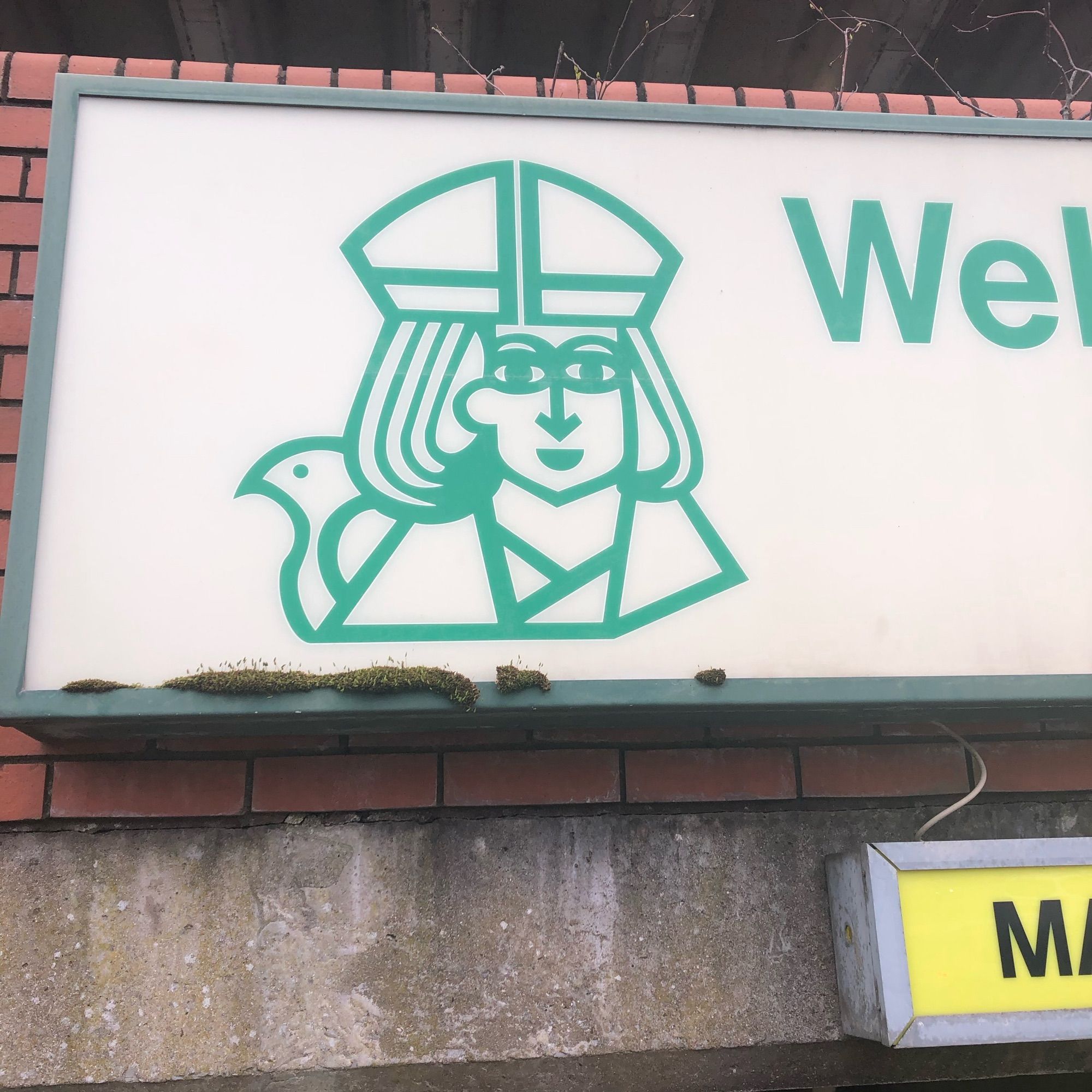 A stylised depiction of St. David on the sign for the St. David’s Shopping Centre car park in Swansea