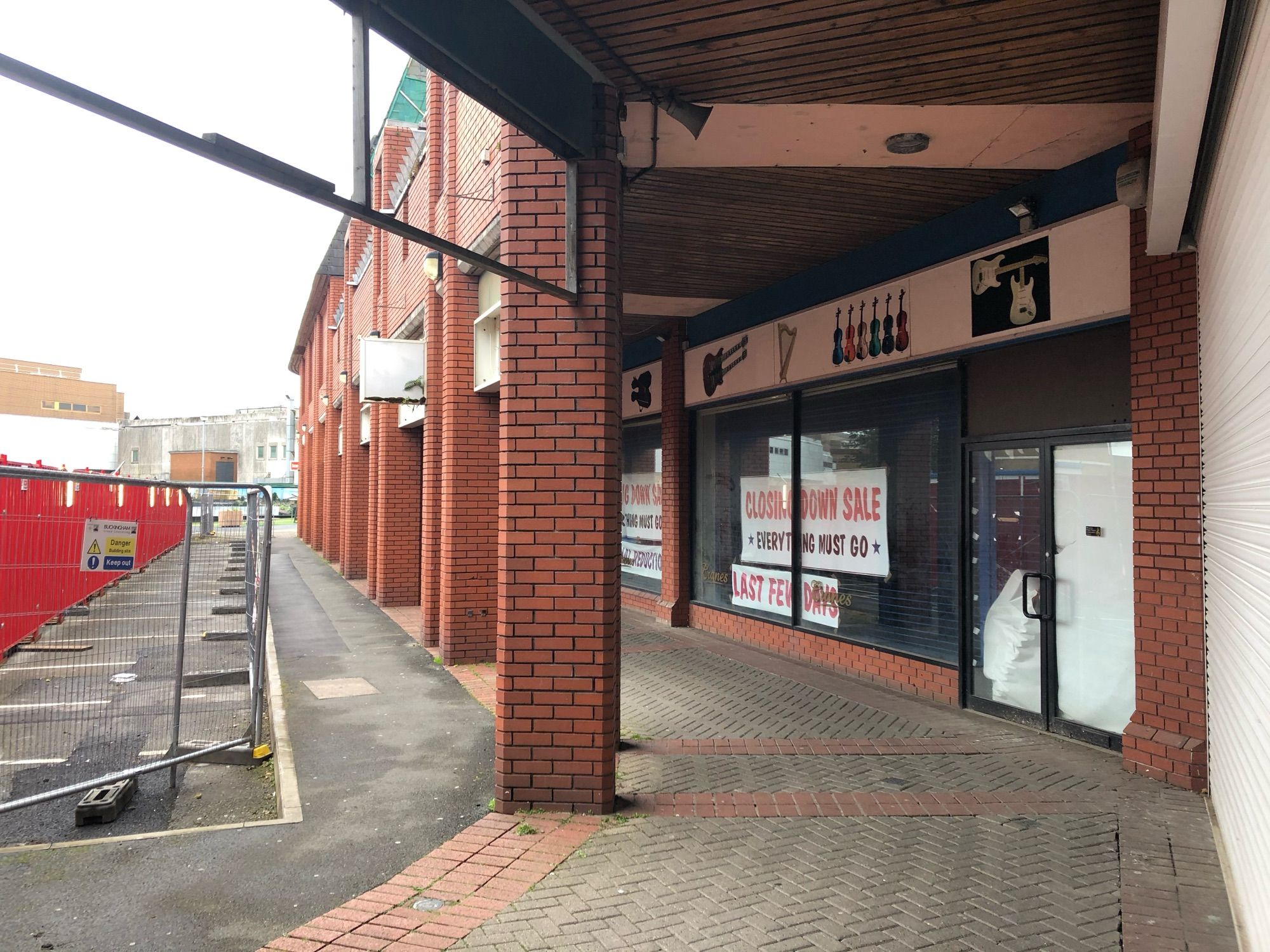 A closed-down shop in the red-brick open-air St. David’s Shopping Centre in Swansea. The sign says ‘Closing Down Sale’.