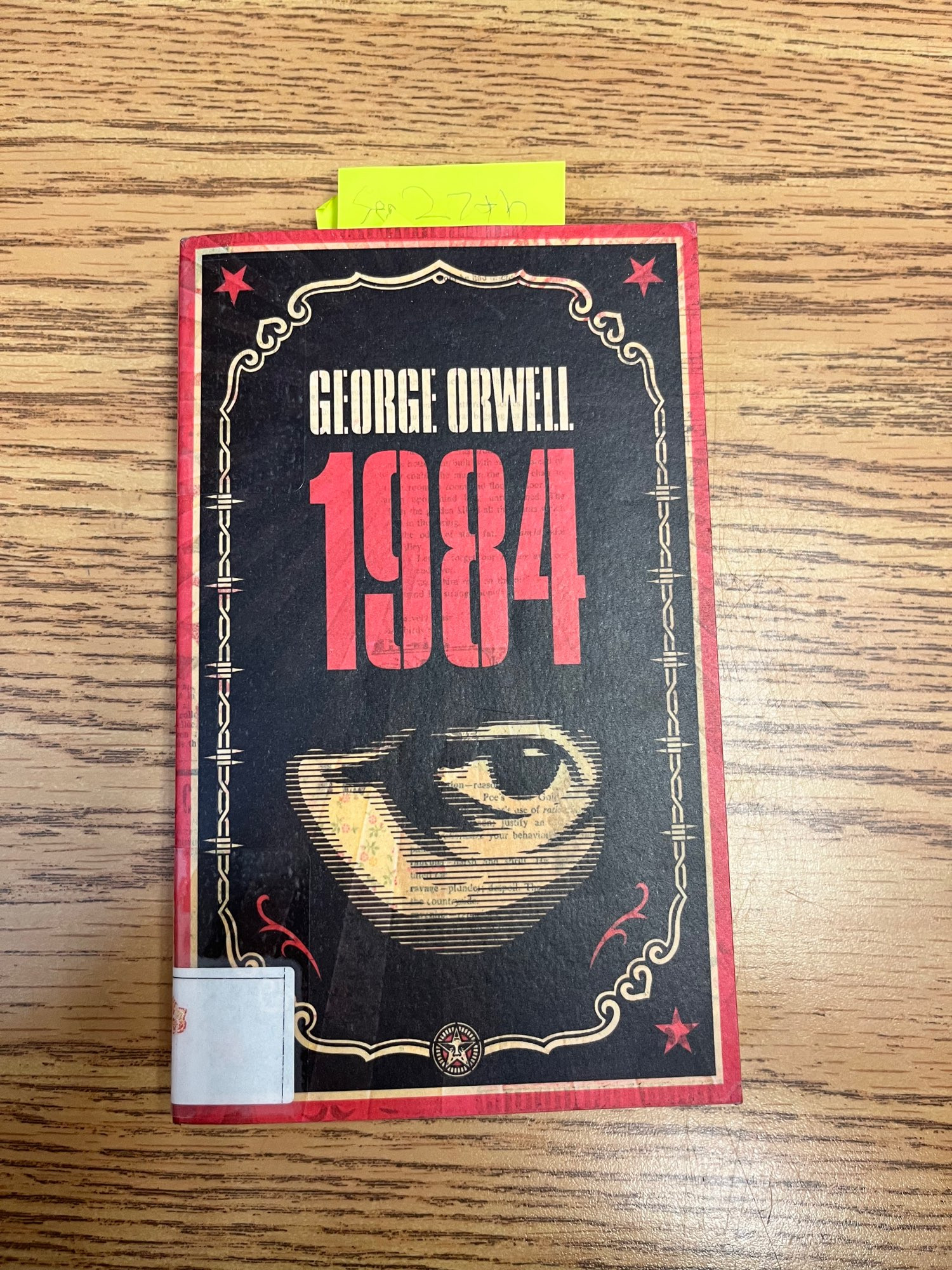 A copy of George Orwell’s 1984 that has a yellow sticky note in it that reads “September 27th.”