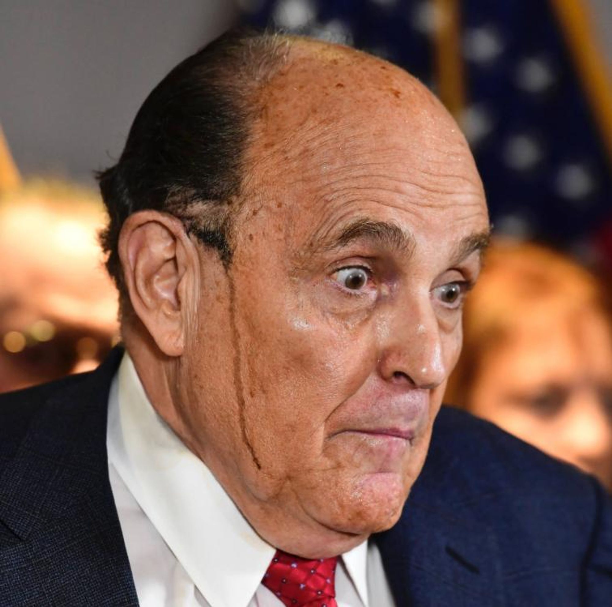 Rudy Giuliani Surprised with spray can hair running down his face 

That’s gotta be what that streak is right?