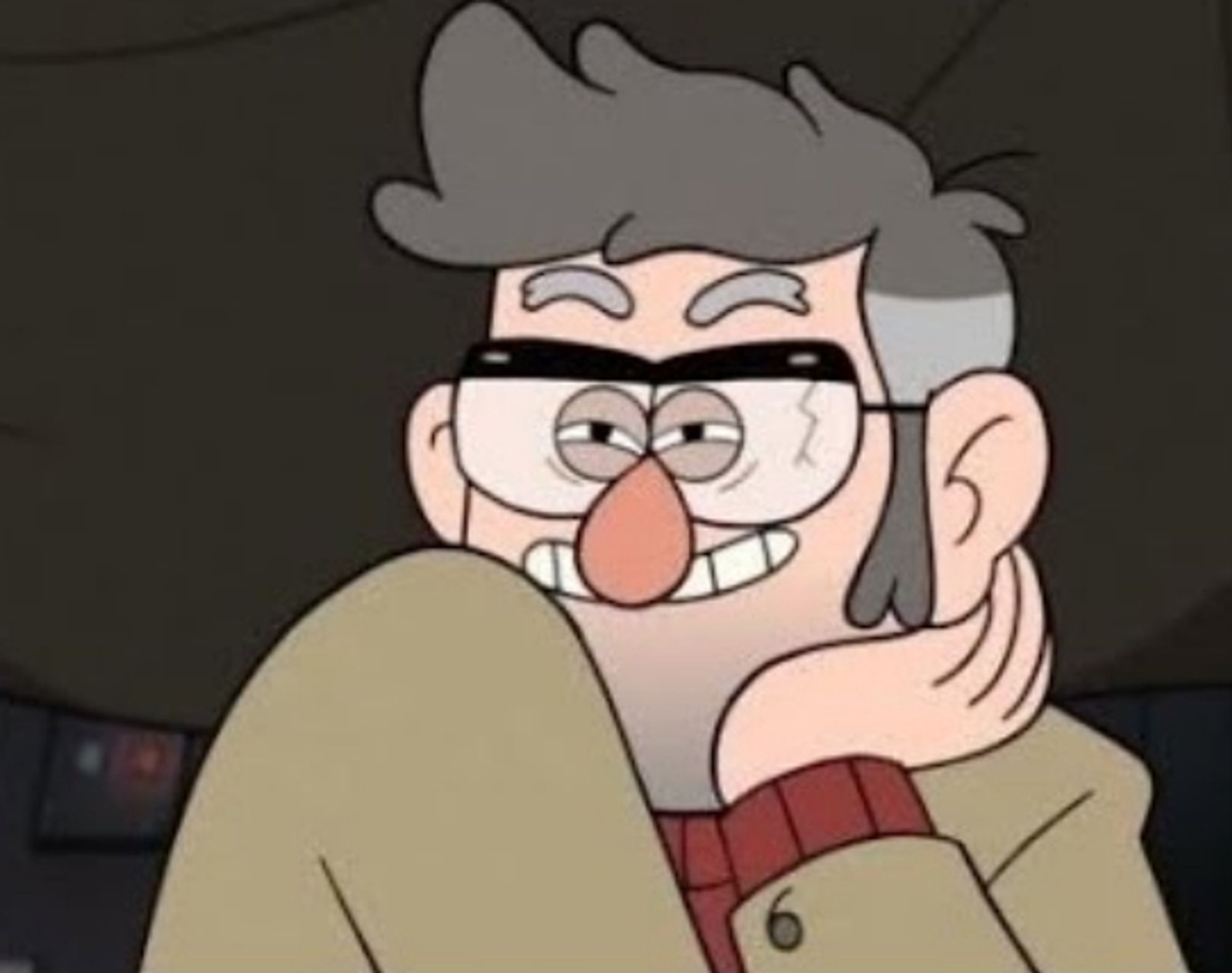 A screenshot of Grunkle Ford from Gravity Falls. He is an older man wearing cracked glasses and a tan coat, and is smiling flirtatiously with his chin in his hand.